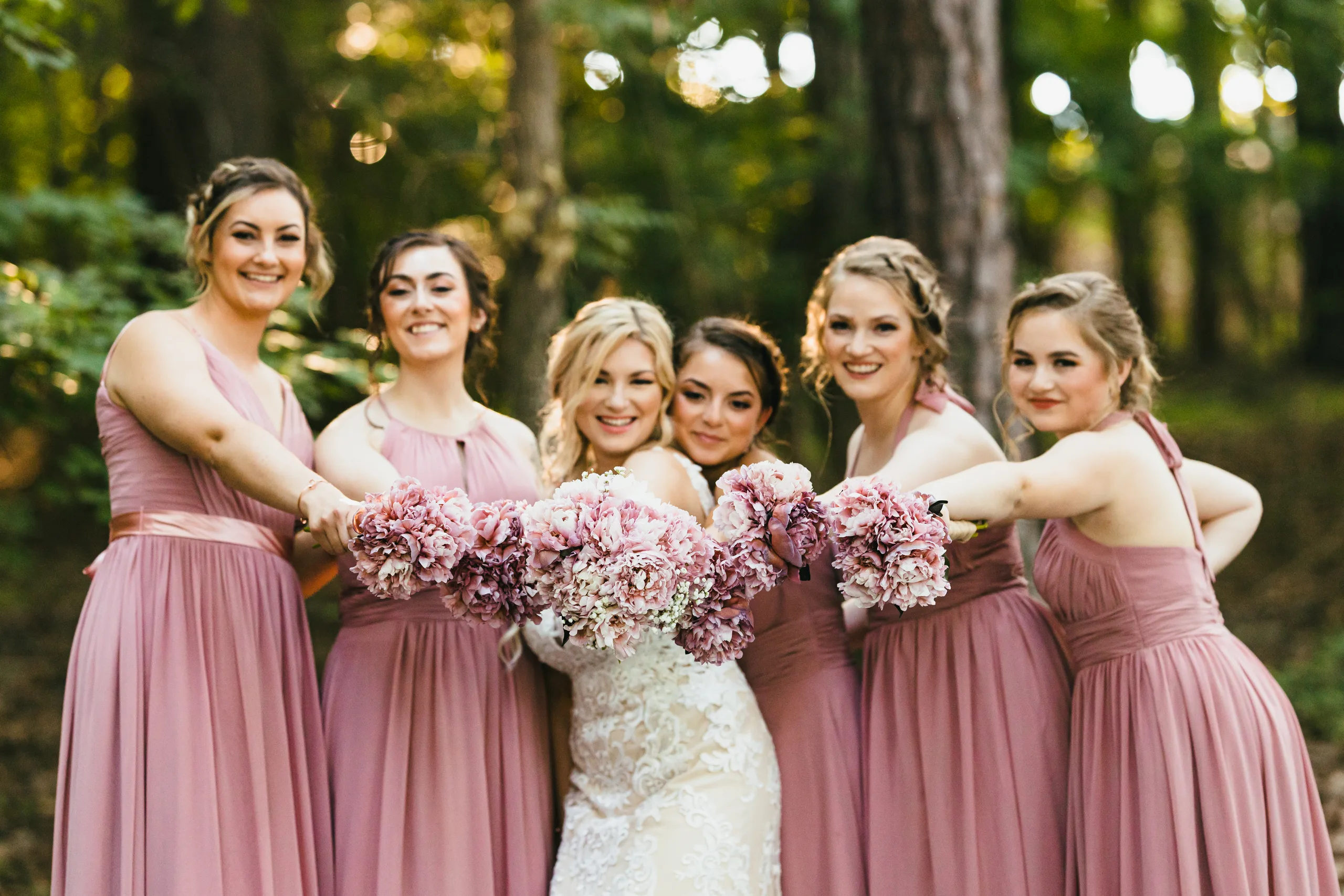 Wedding Party: the bride and her bridesmaids in blush with their bouquets, at their wedding at Atlanta Evergreen Lakeside Resort in Stone Mountain, GA