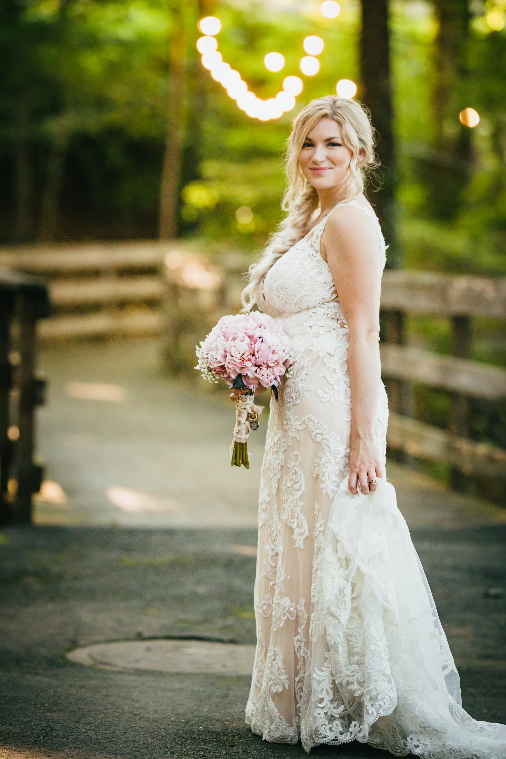 Bridal Portraits: the bride on the footbridge with her bouquet, at their wedding at Atlanta Evergreen Lakeside Resort in Stone Mountain, GA