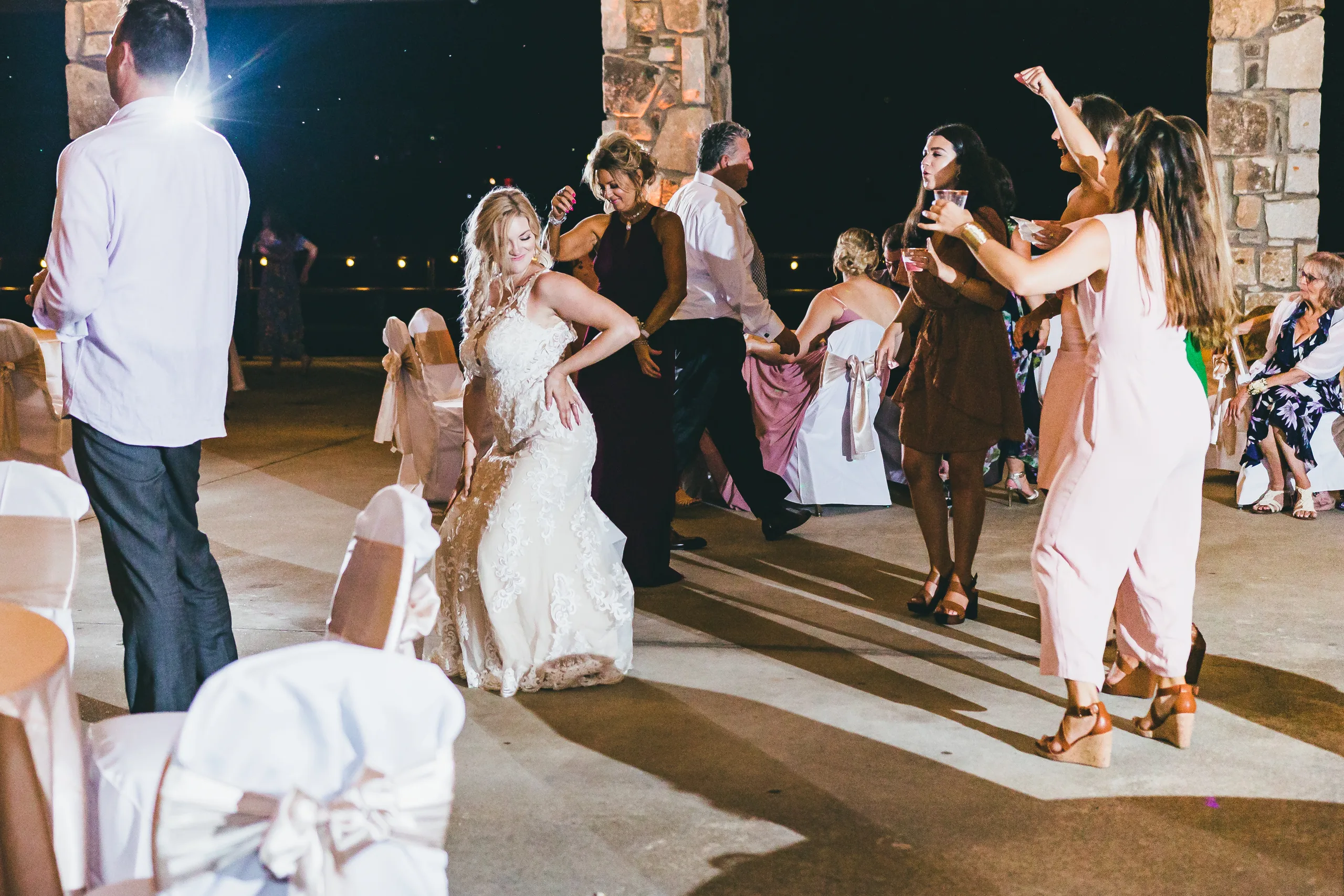 Reception: the bride dancing with her guests under the pavilion, at their wedding at Atlanta Evergreen Lakeside Resort in Stone Mountain, GA