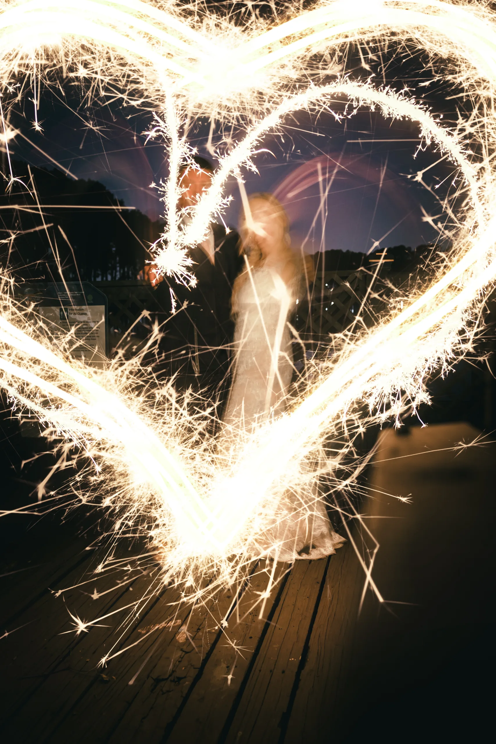Wedding Formals: a sparkler heart drawn around them on the dock, at their wedding at Atlanta Evergreen Lakeside Resort in Stone Mountain, GA