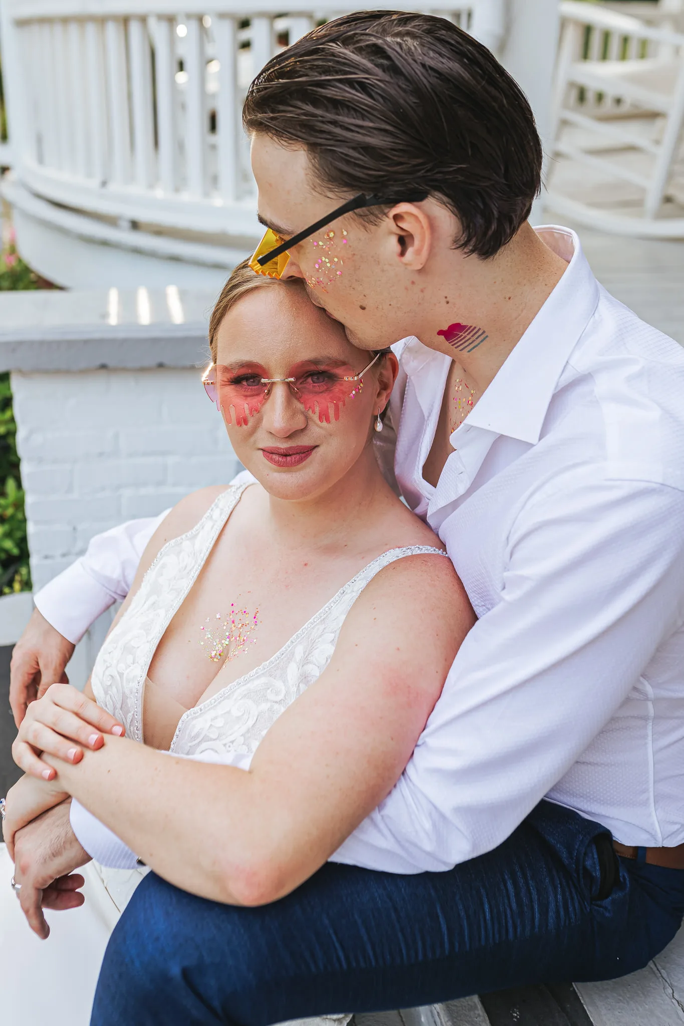 Wedding Formals: the two of them in heart sunglasses and face gems on the porch steps, at their wedding at The Wildflower 301 in Greensboro, GA
