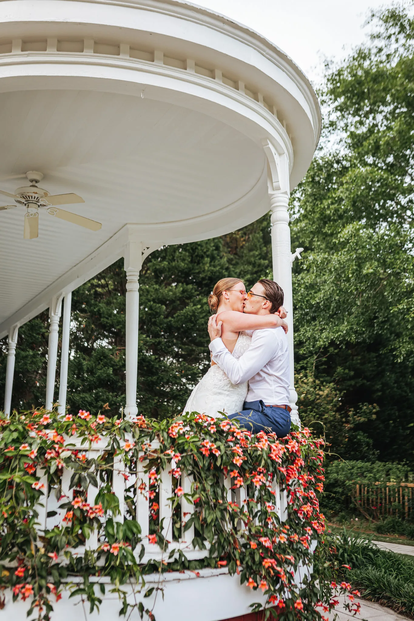 Wedding Formals: a kiss on the flowered gazebo, at their wedding at The Wildflower 301 in Greensboro, GA