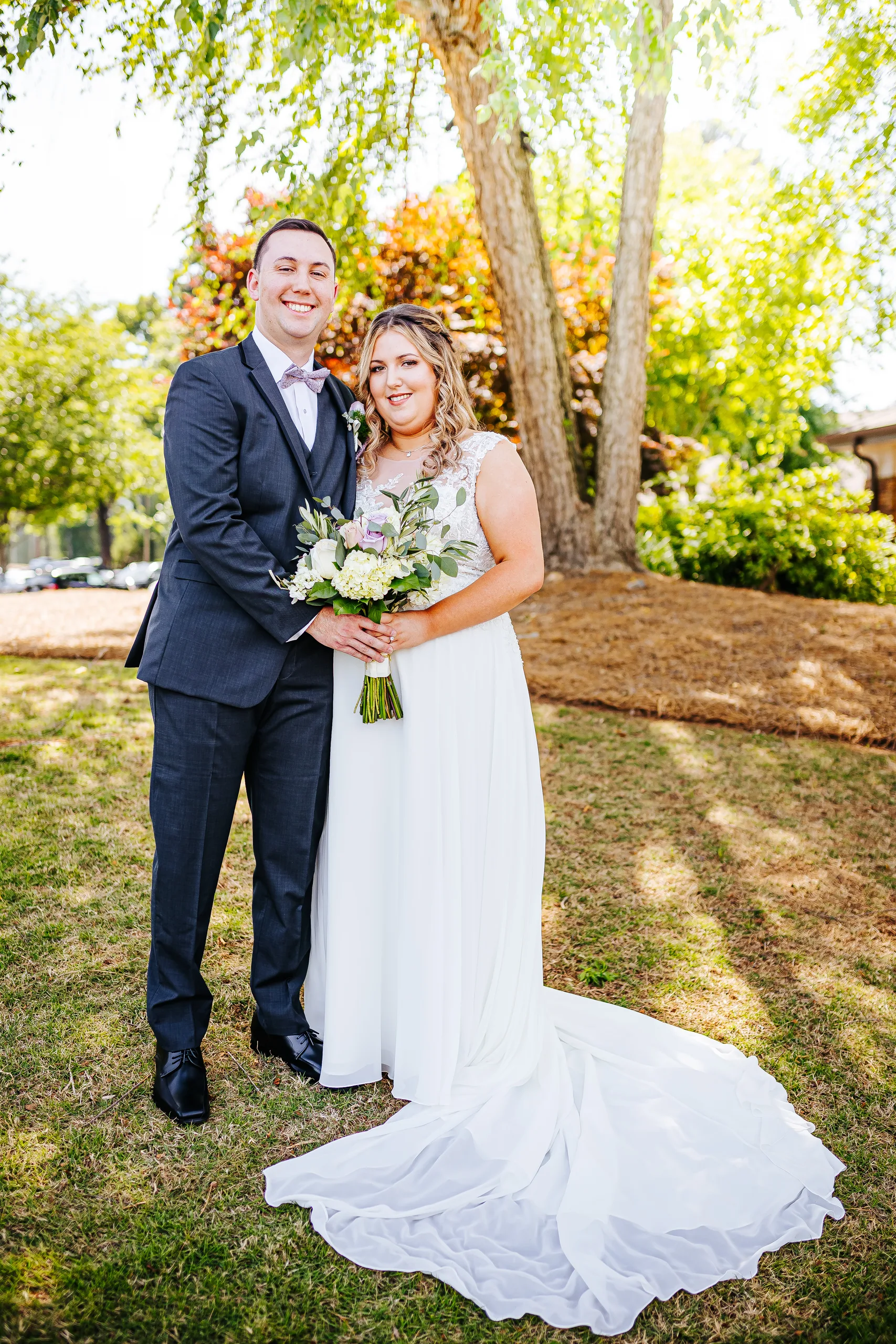 Wedding Formals: standing together under the willow tree at their wedding at the Country Club of Roswell in Roswell, GA