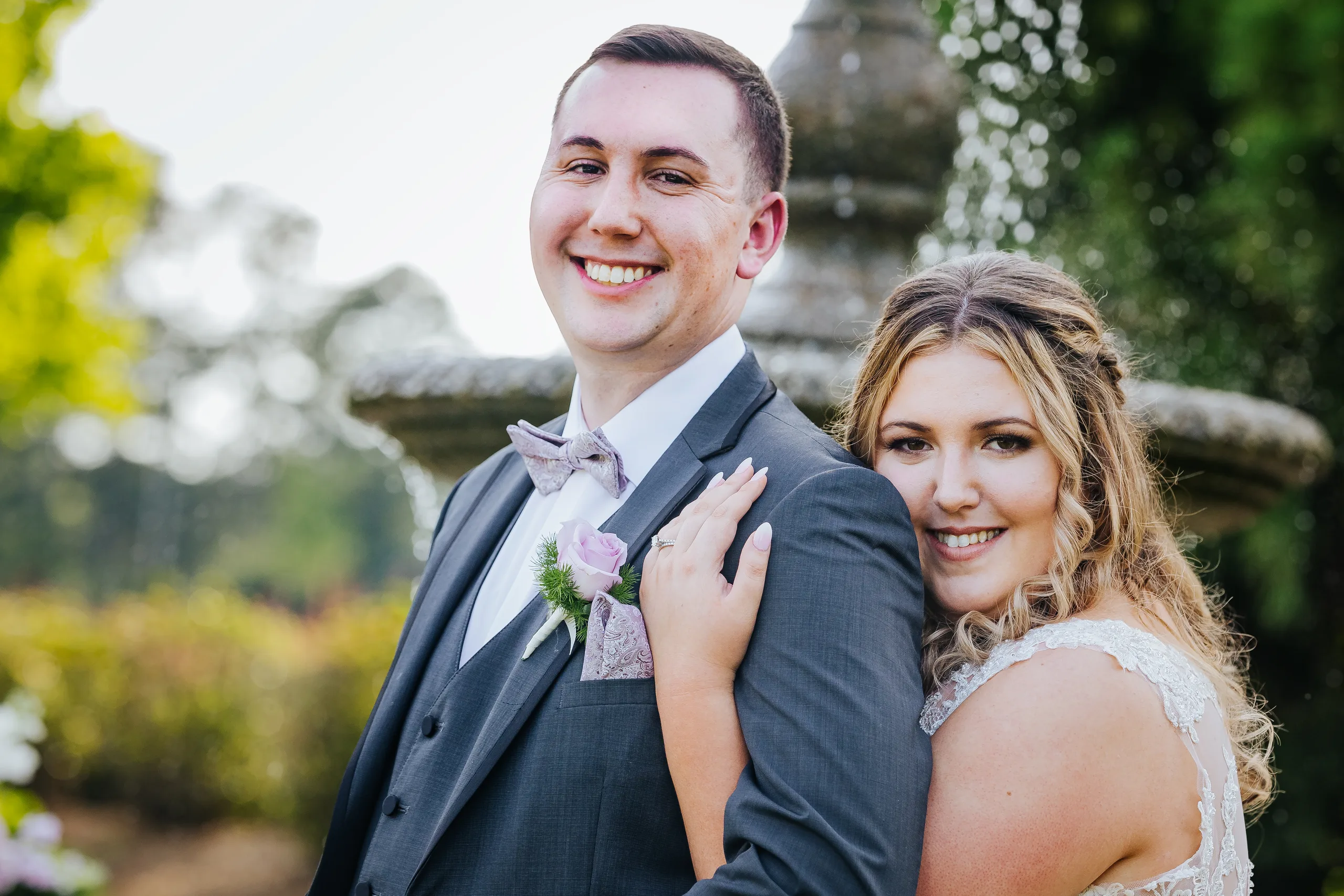 Wedding Formals: cheek to cheek by the fountain at their wedding at the Country Club of Roswell in Roswell, GA