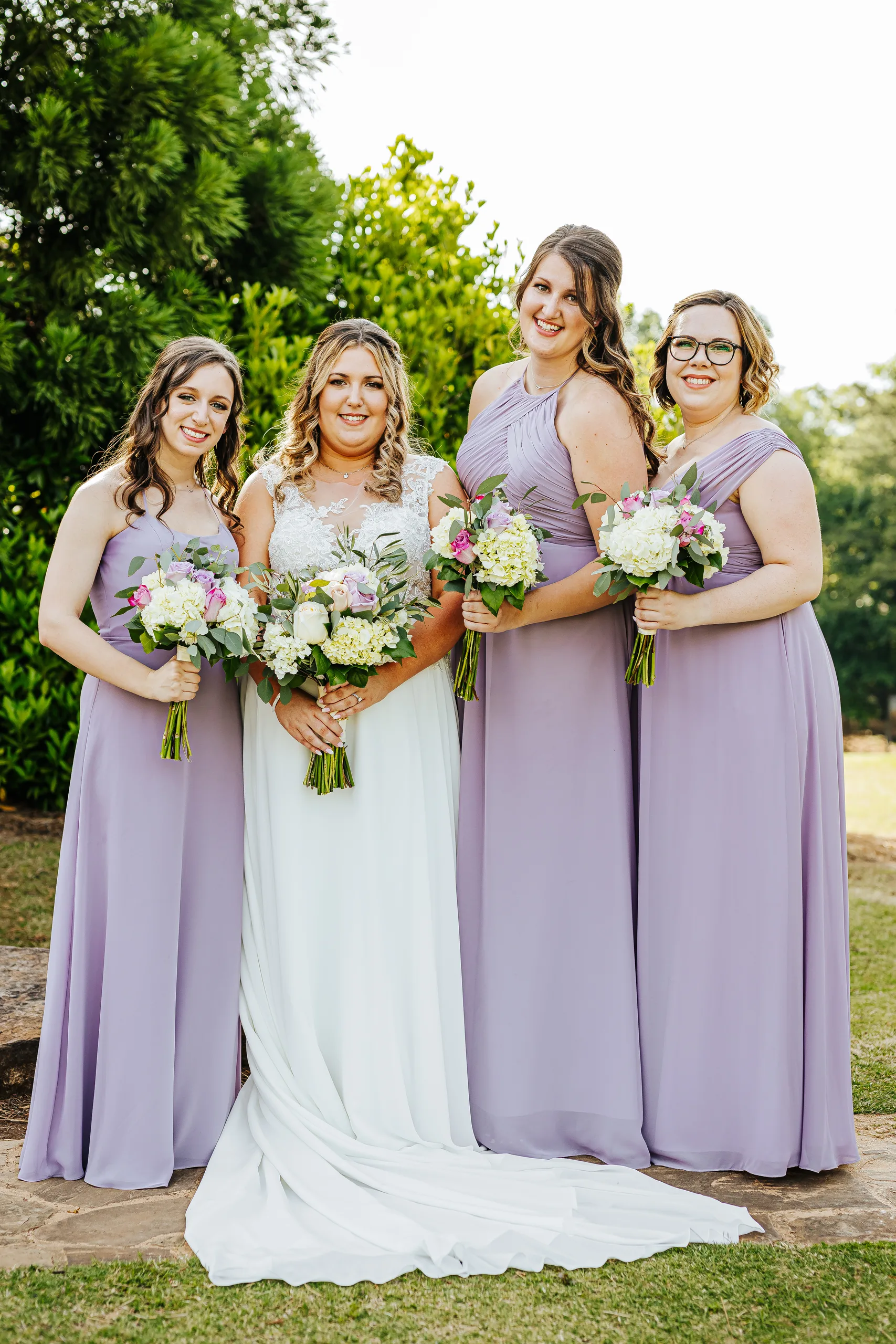 Wedding Party: the bride with her bridesmaids in lavender at their wedding at the Country Club of Roswell in Roswell, GA