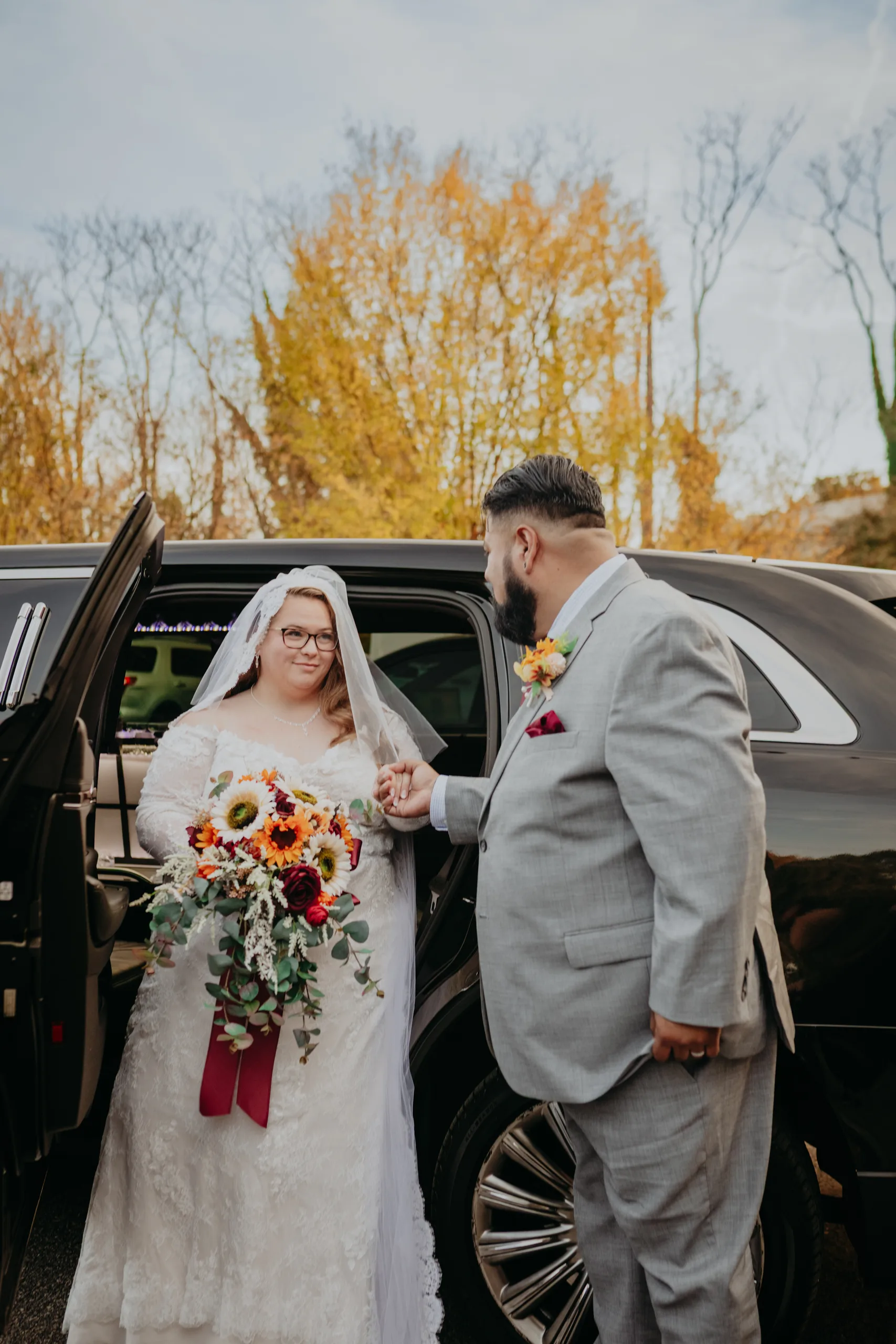 Wedding Formals: the groom helping her out of the car, at their wedding at 550 Trackside in Lawrenceville, GA