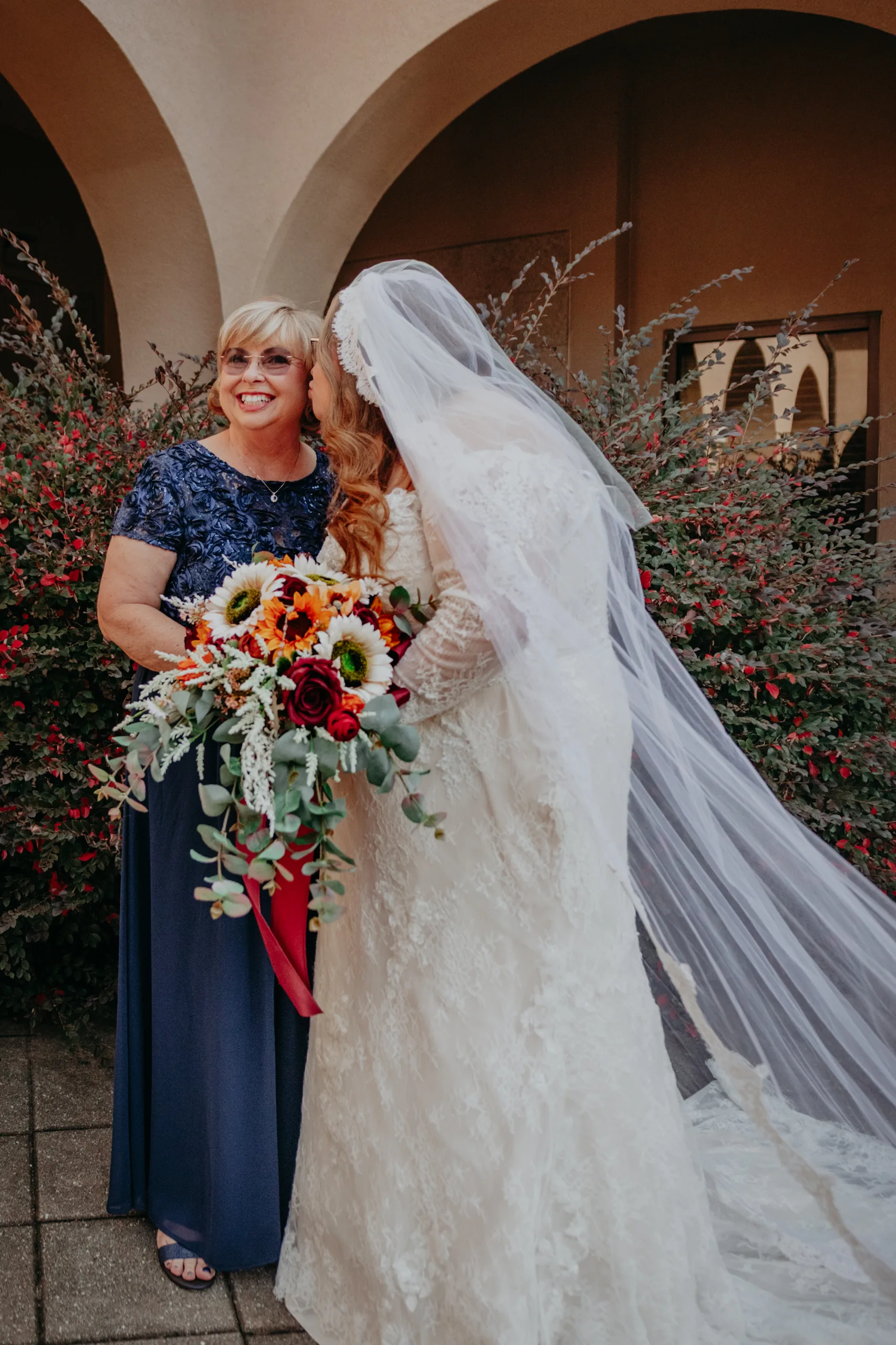 Family Formals: the bride with her mom in the courtyard, at their wedding at St. Lawrence Catholic Church in Lawrenceville, GA