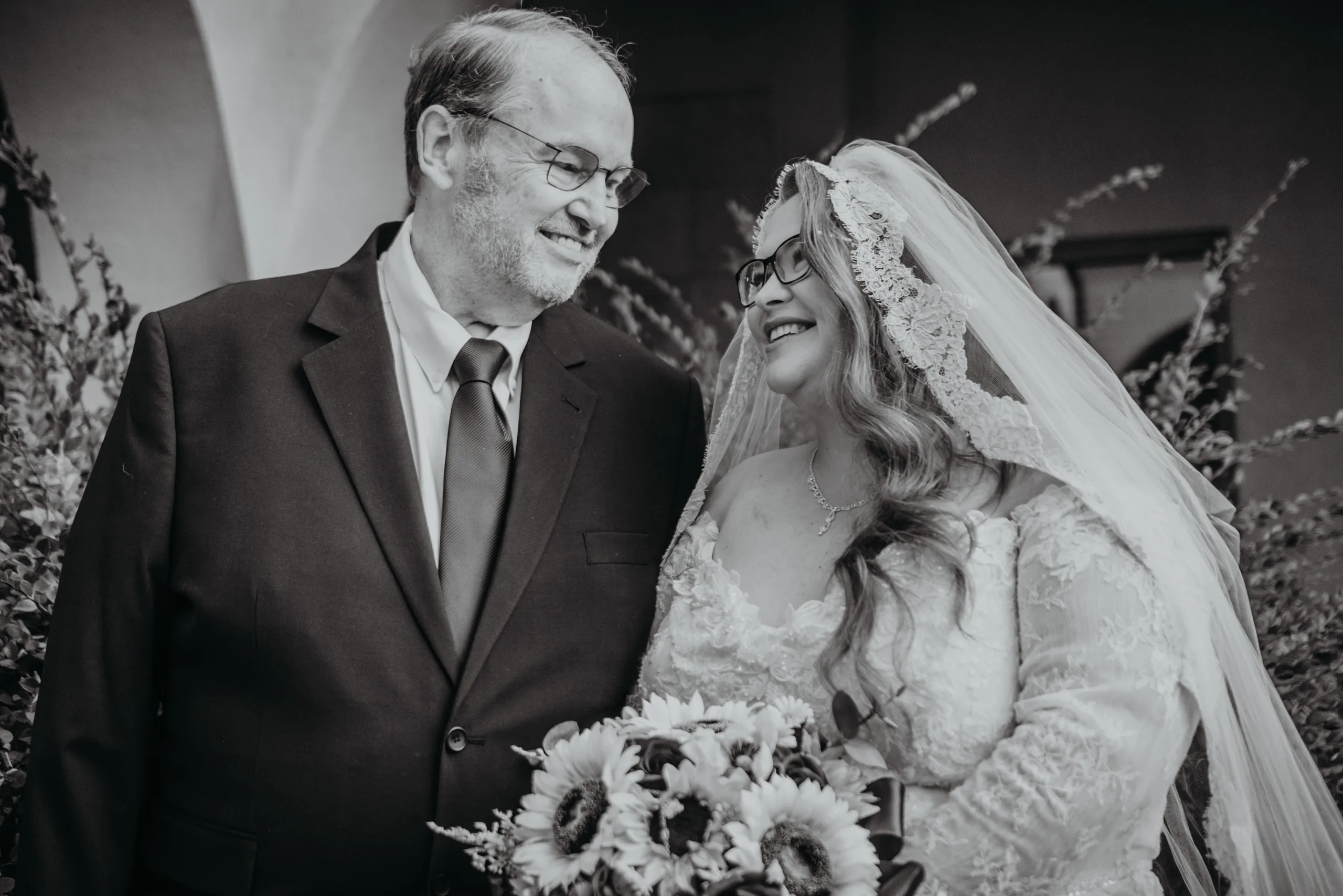 Family Formals: the bride with her dad, in black and white, at their wedding at St. Lawrence Catholic Church in Lawrenceville, GA
