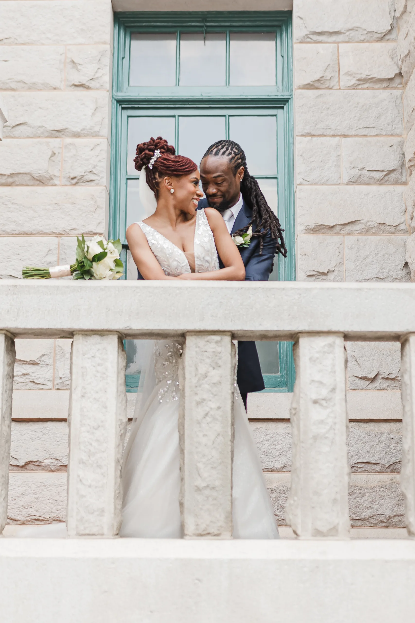 Wedding Formals: close together on the stone balcony, at their wedding at the Historic DeKalb Courthouse in Decatur, GA