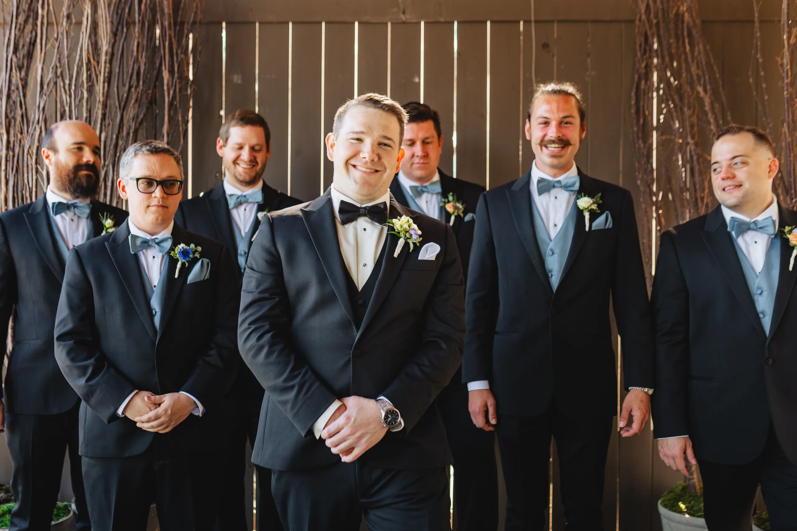 Wedding Party: the groom and his groomsmen in black tuxes at their wedding at Ivy Hall at Roswell Mill in Roswell, GA