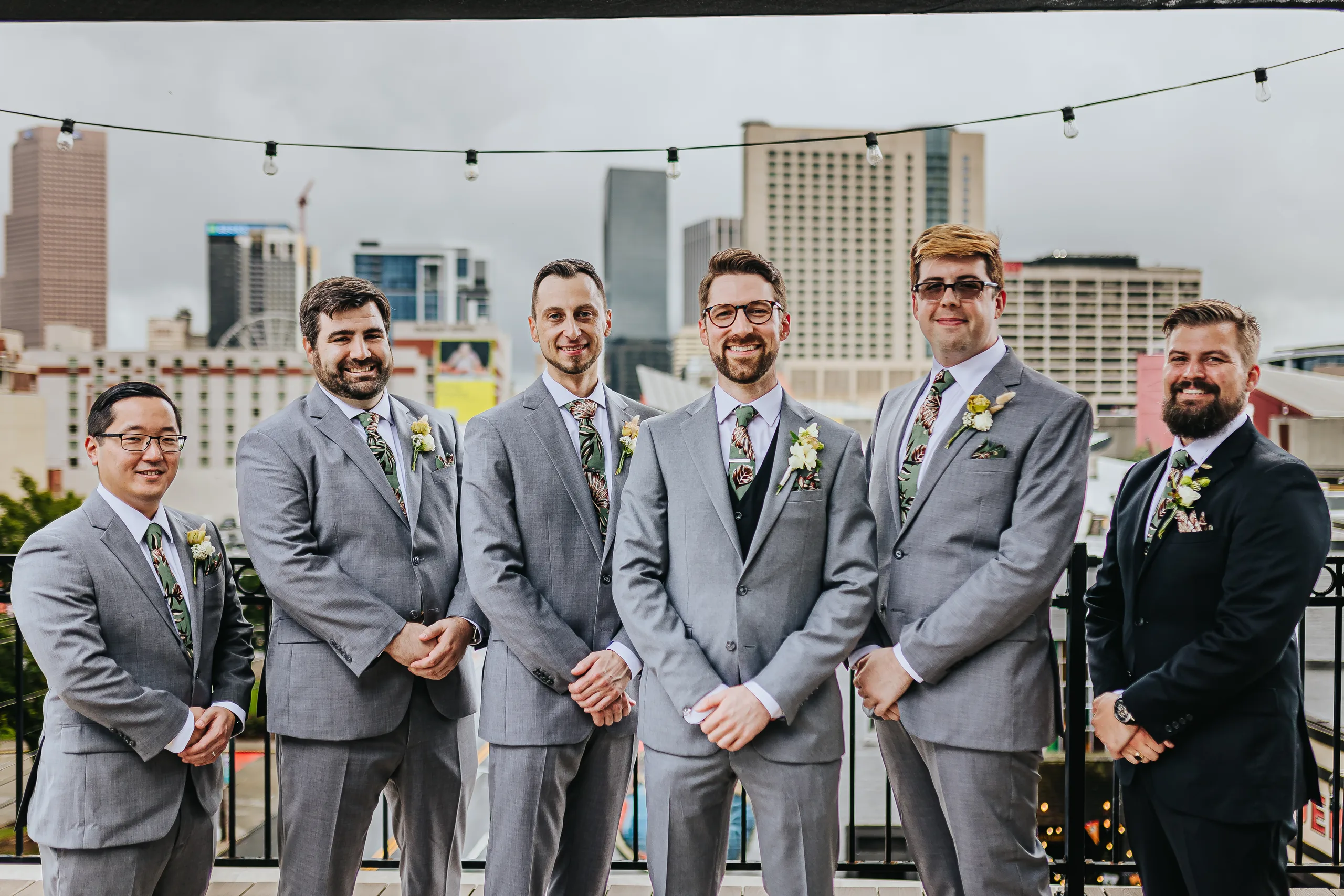 Wedding Party: the groom and his groomsmen on the rooftop with the downtown skyline, at their wedding at Terminus 330 in Atlanta, GA