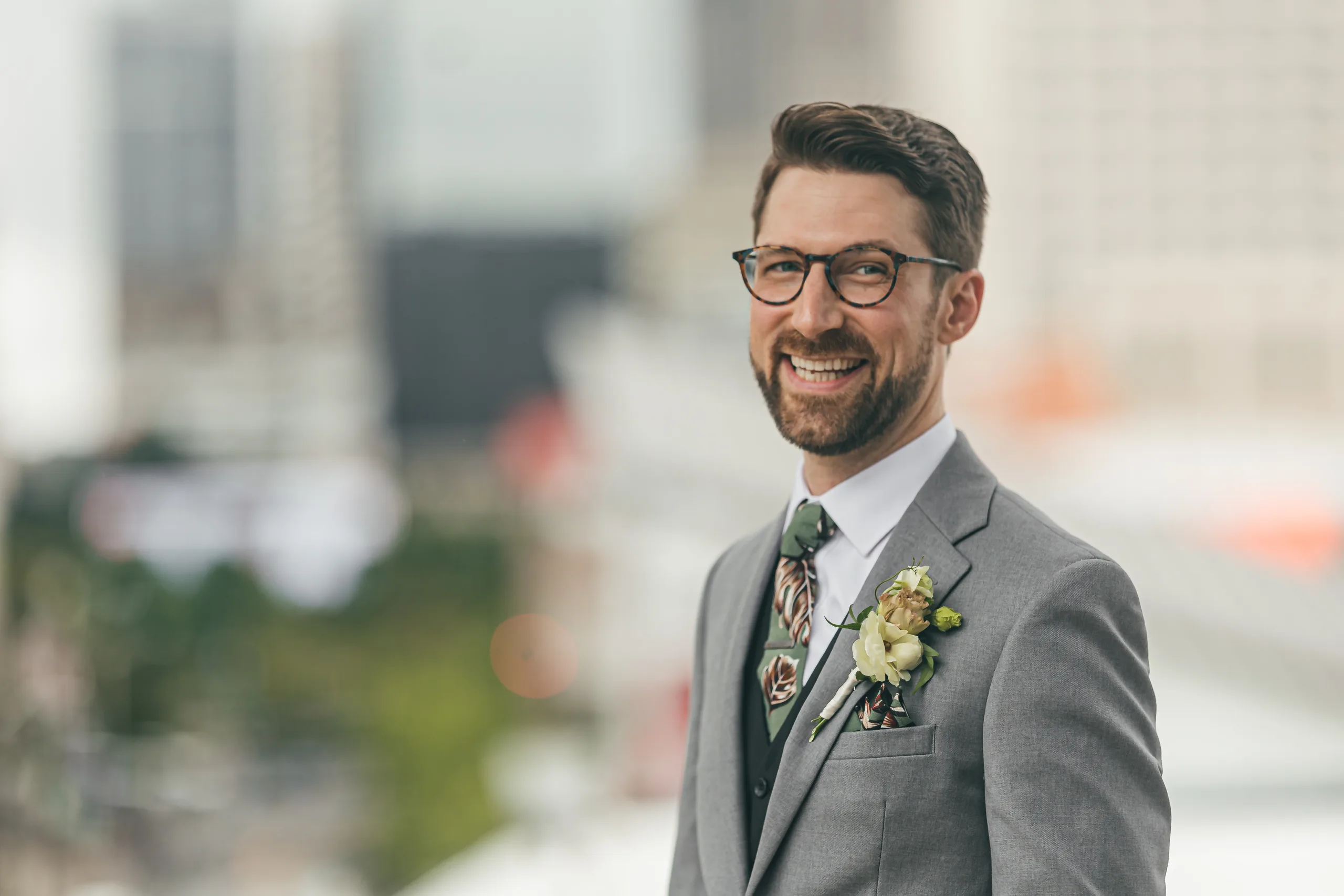 Wedding Formals: the groom on the rooftop with the city behind him, at their wedding at Terminus 330 in Atlanta, GA