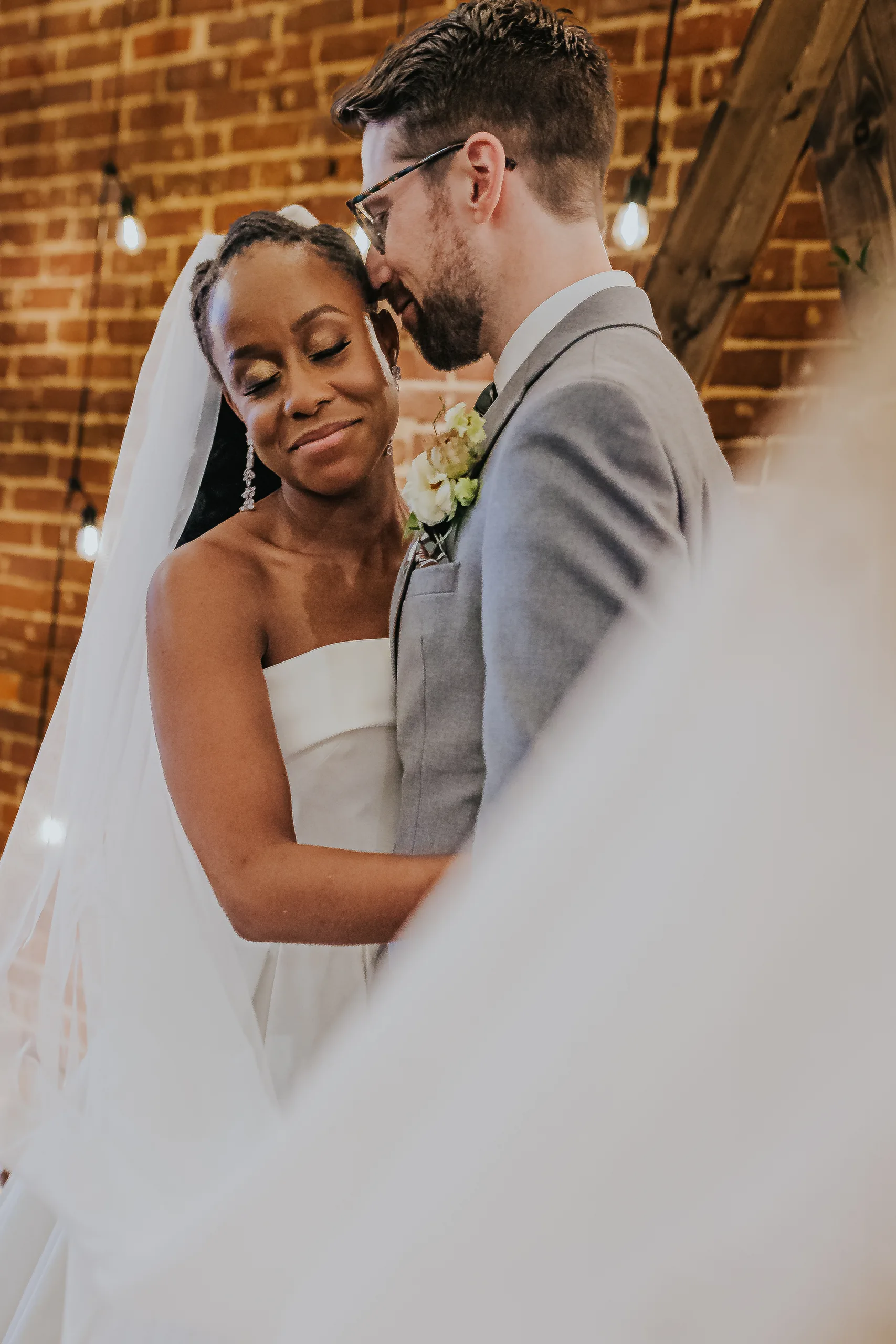 Wedding Formals: the two of them close under her veil, at their wedding at Terminus 330 in Atlanta, GA