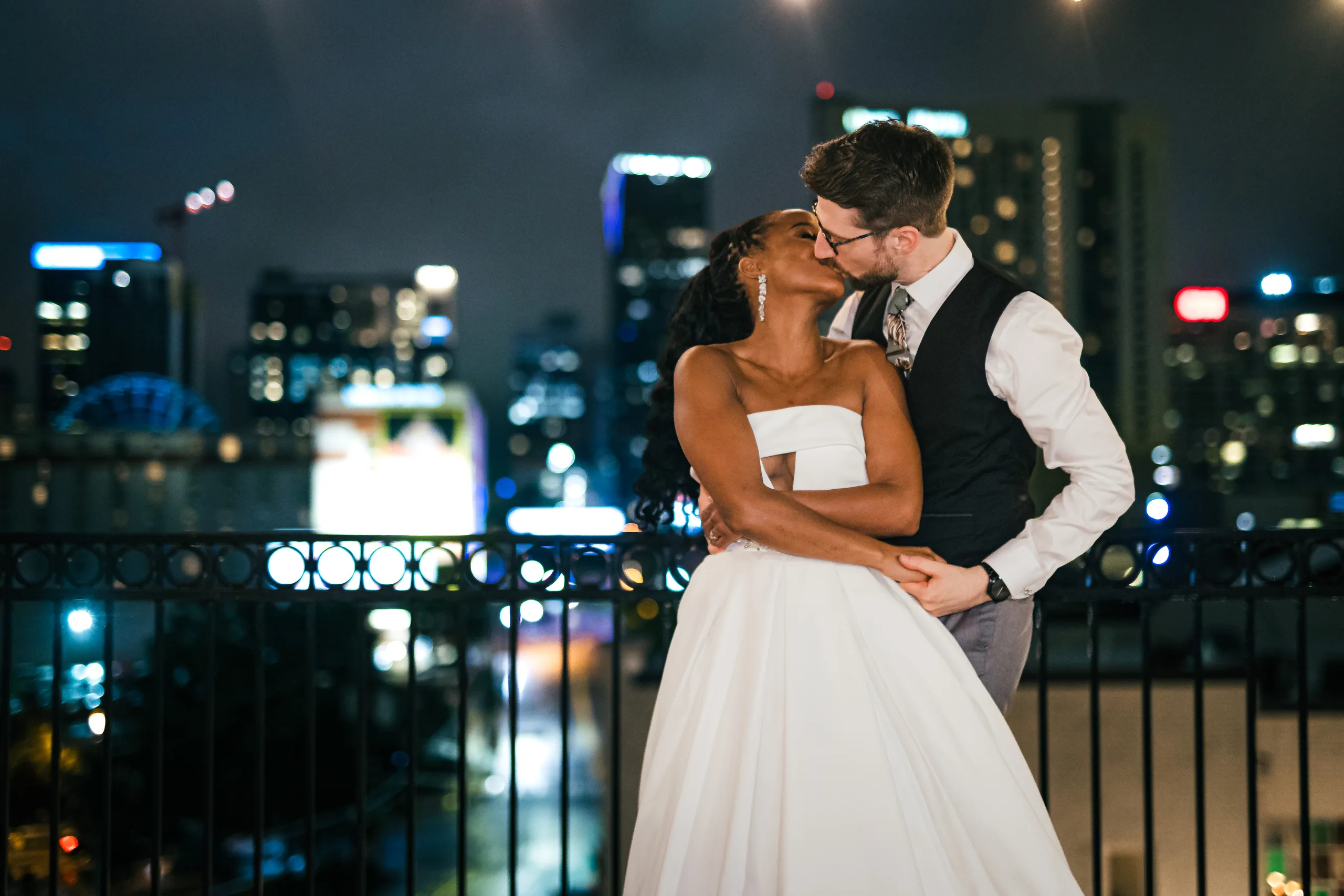 Wedding Formals: a kiss on the rooftop at night, at their wedding at Terminus 330 in Atlanta, GA