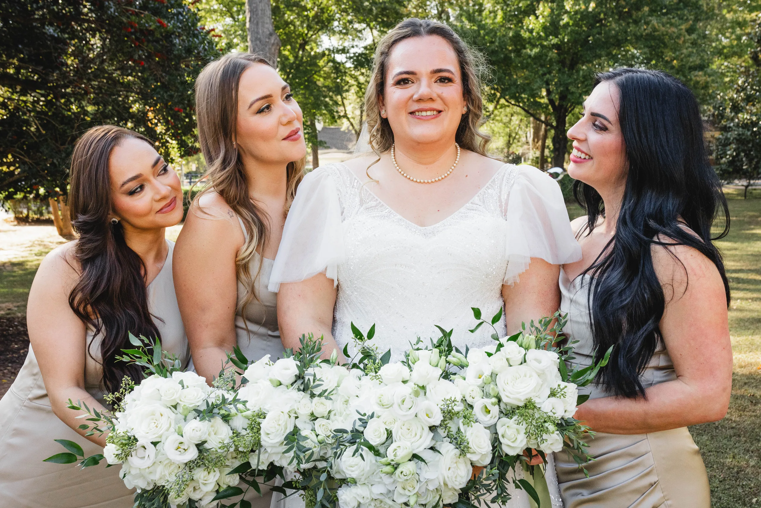 Wedding Party: the bride and her bridesmaids in champagne with their bouquets, at their wedding at Naylor Hall in Roswell, GA
