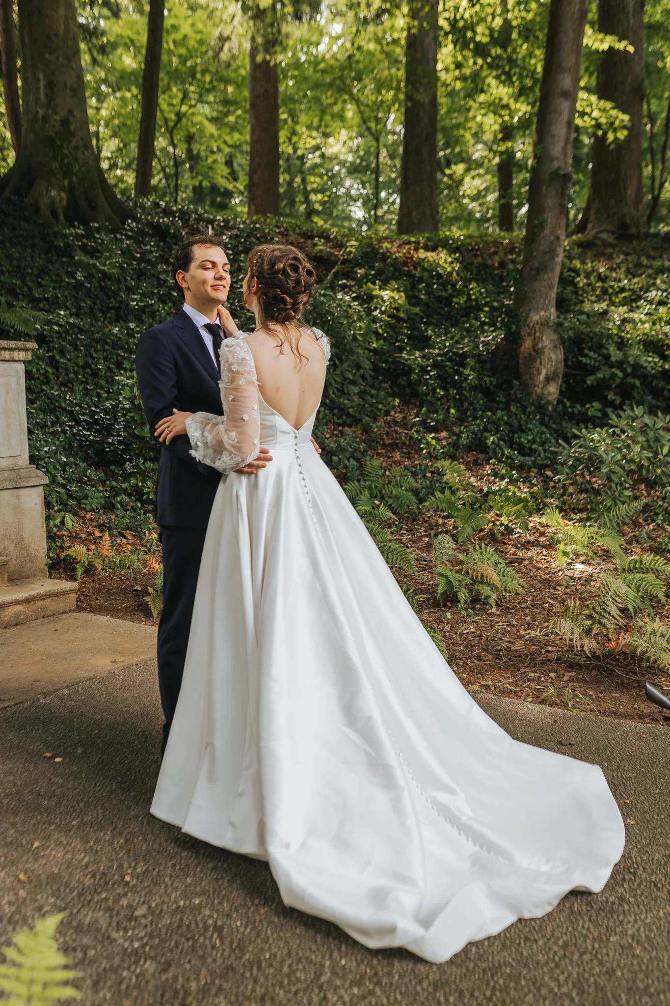 First Look: a hug after the first look under the trees, on their wedding day at Cator Woolford Gardens in Atlanta, GA