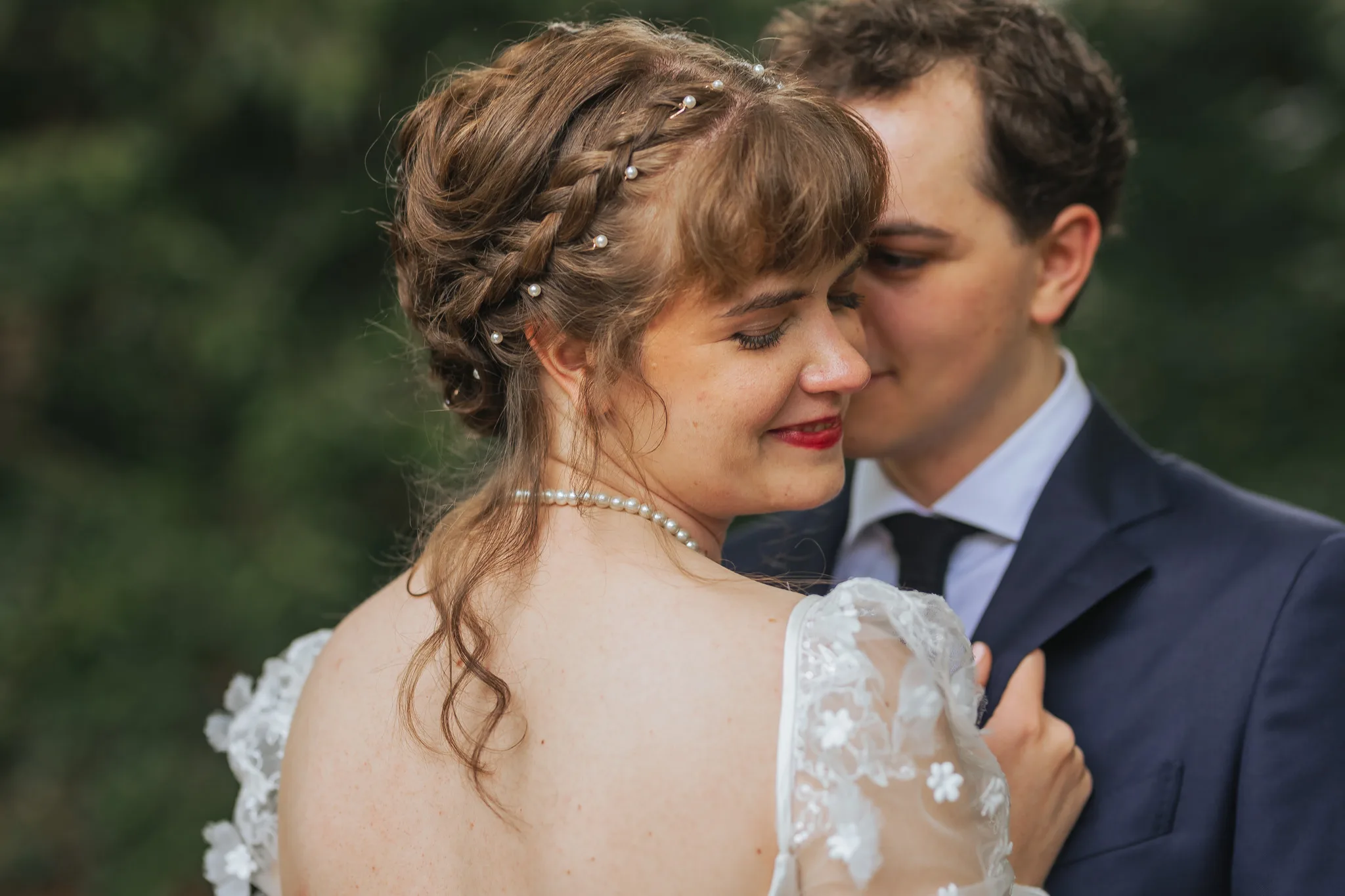 Wedding Formals: close together, her braids and pearls in focus, on their wedding day at Cator Woolford Gardens in Atlanta, GA