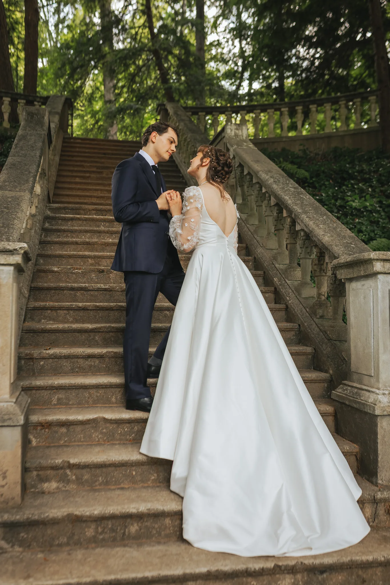 Wedding Formals: holding hands on the stone staircase, on their wedding day at Cator Woolford Gardens in Atlanta, GA