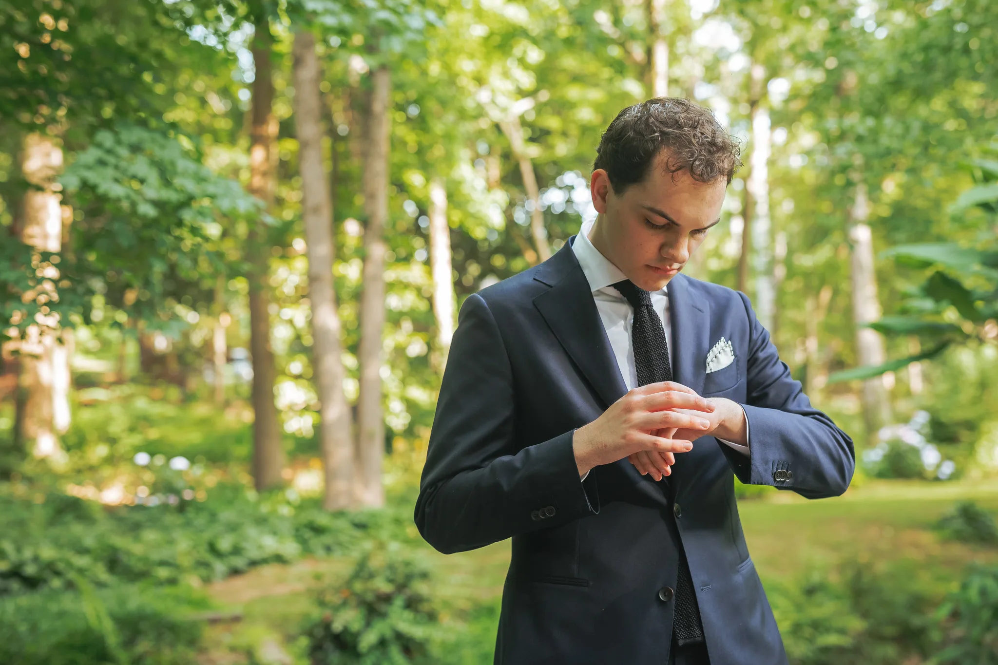 Wedding Formals: the groom fixing his cufflinks, on their wedding day at Cator Woolford Gardens in Atlanta, GA