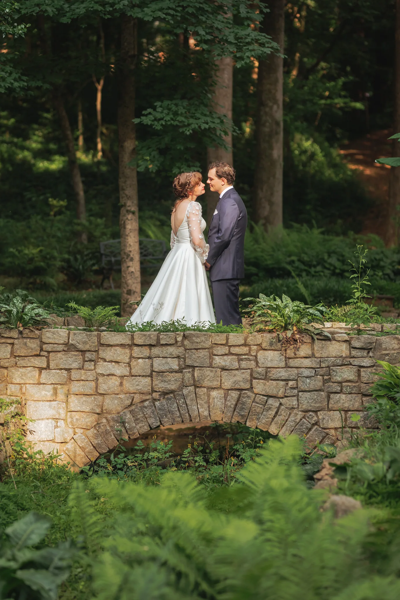Wedding Formals: face to face on the stone bridge, on their wedding day at Cator Woolford Gardens in Atlanta, GA