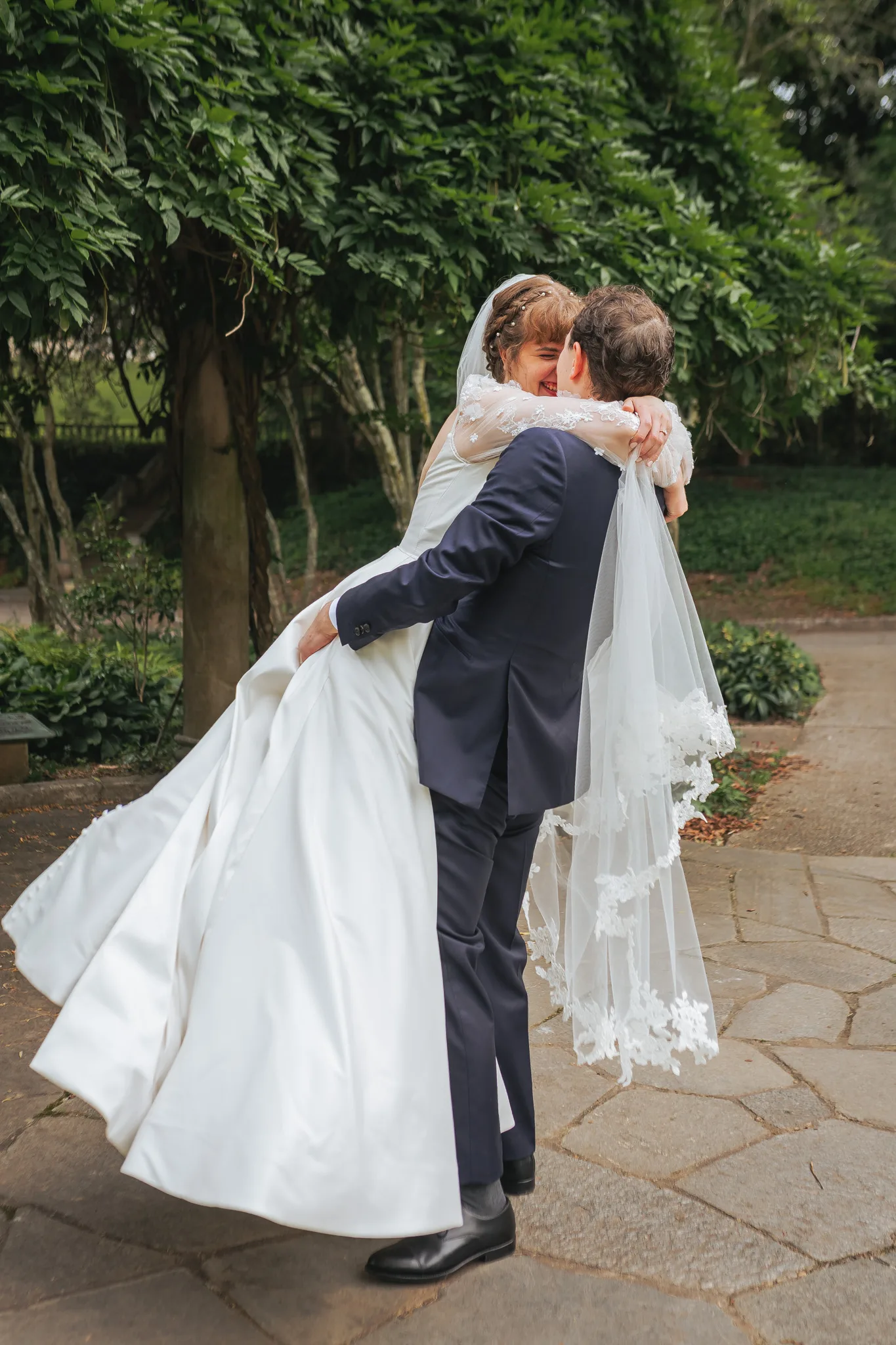 Wedding Formals: the groom lifting her off her feet, on their wedding day at Cator Woolford Gardens in Atlanta, GA