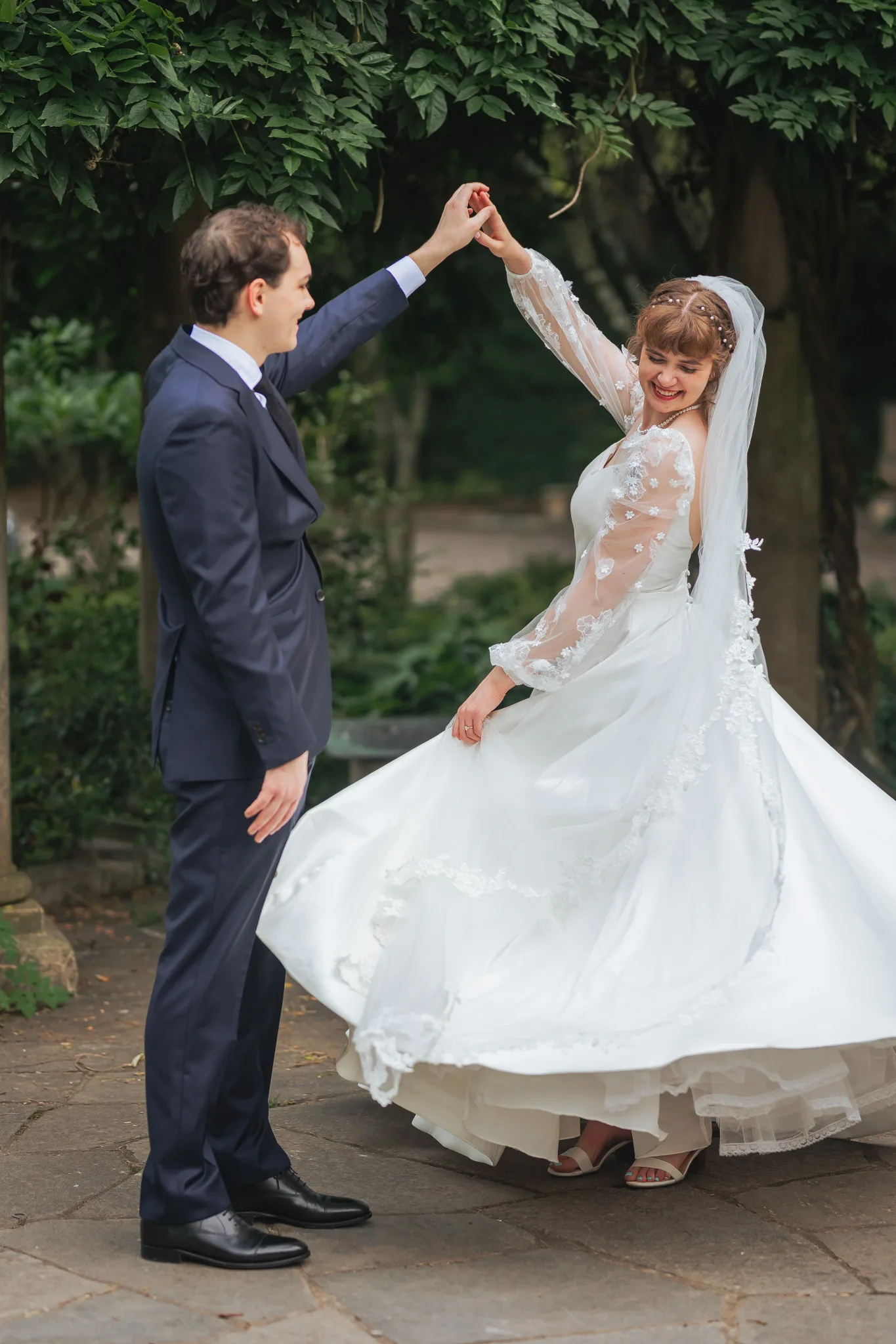 Wedding Formals: the groom twirling her, on their wedding day at Cator Woolford Gardens in Atlanta, GA