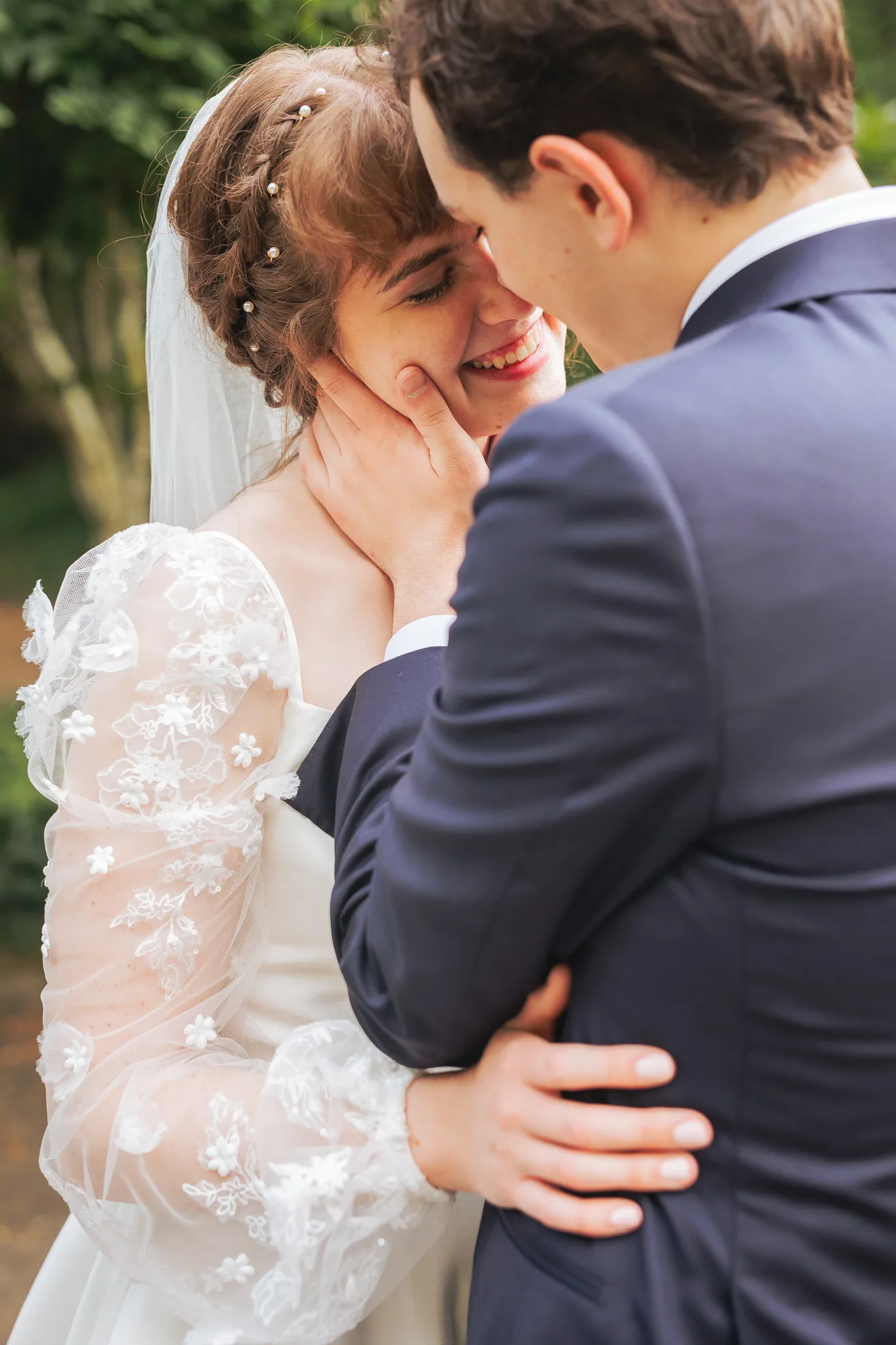 Wedding Formals: laughing with his hand on her cheek, on their wedding day at Cator Woolford Gardens in Atlanta, GA