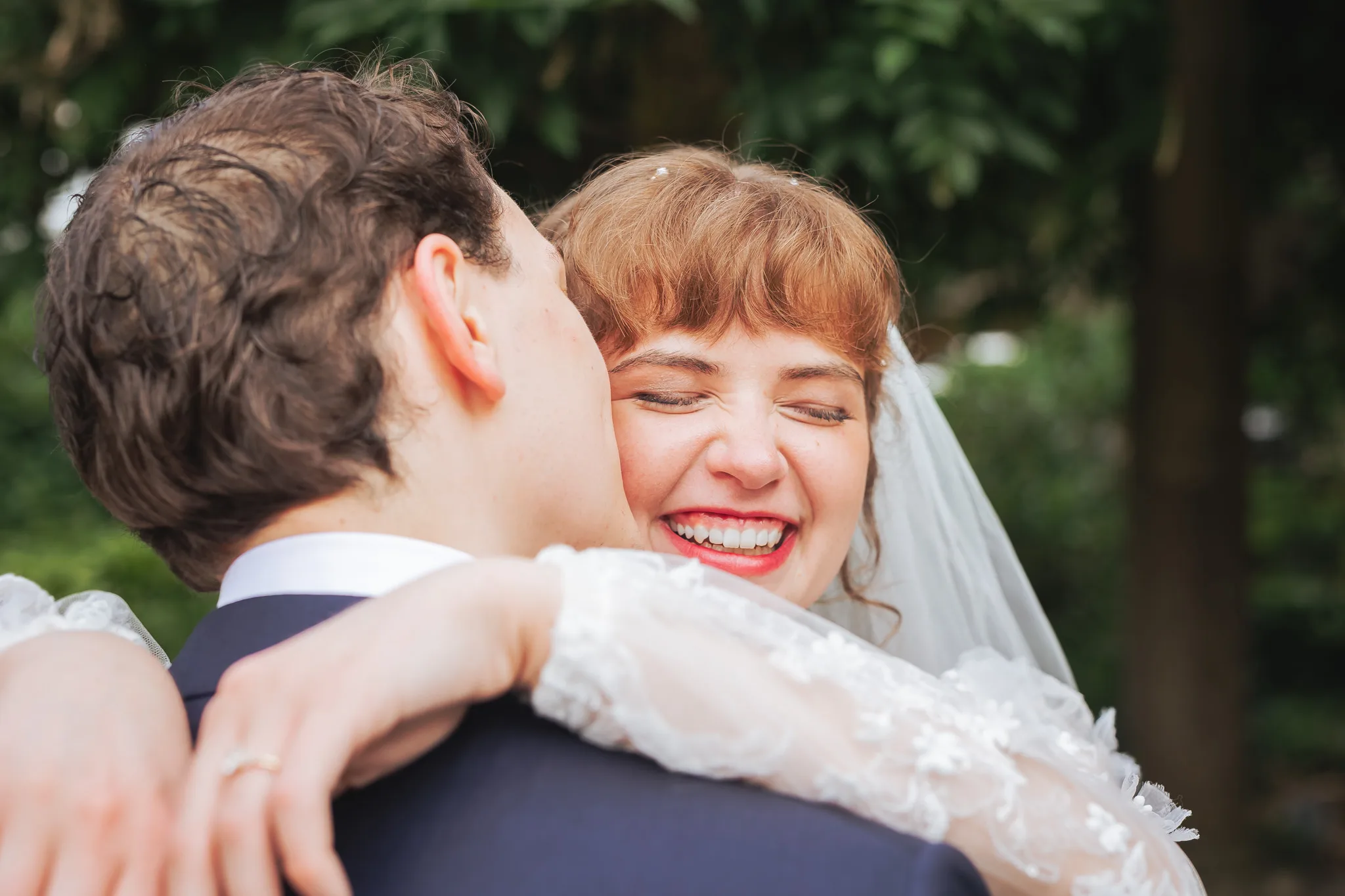 Wedding Formals: a big laughing hug, on their wedding day at Cator Woolford Gardens in Atlanta, GA