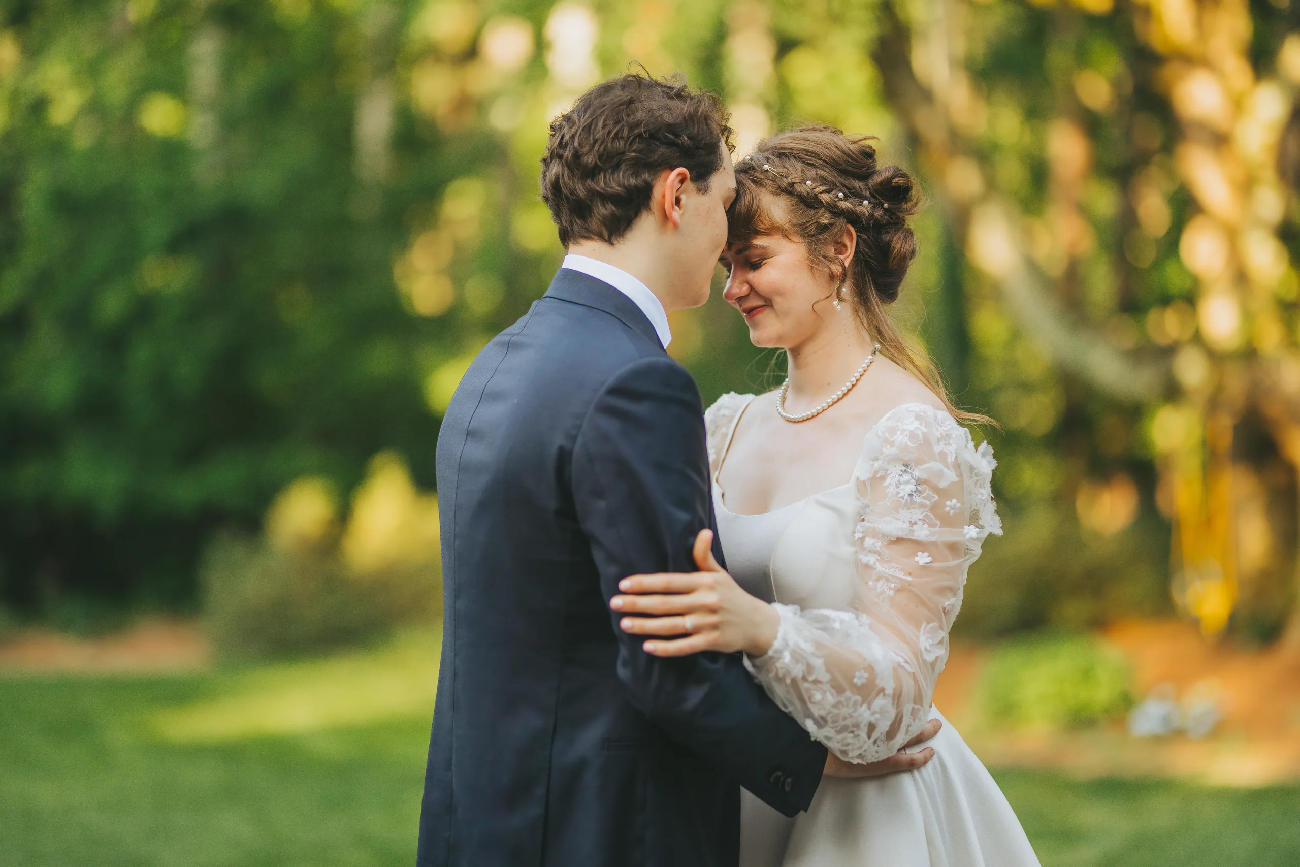 Wedding Formals: foreheads together on the lawn at golden hour, at their wedding reception at a family home