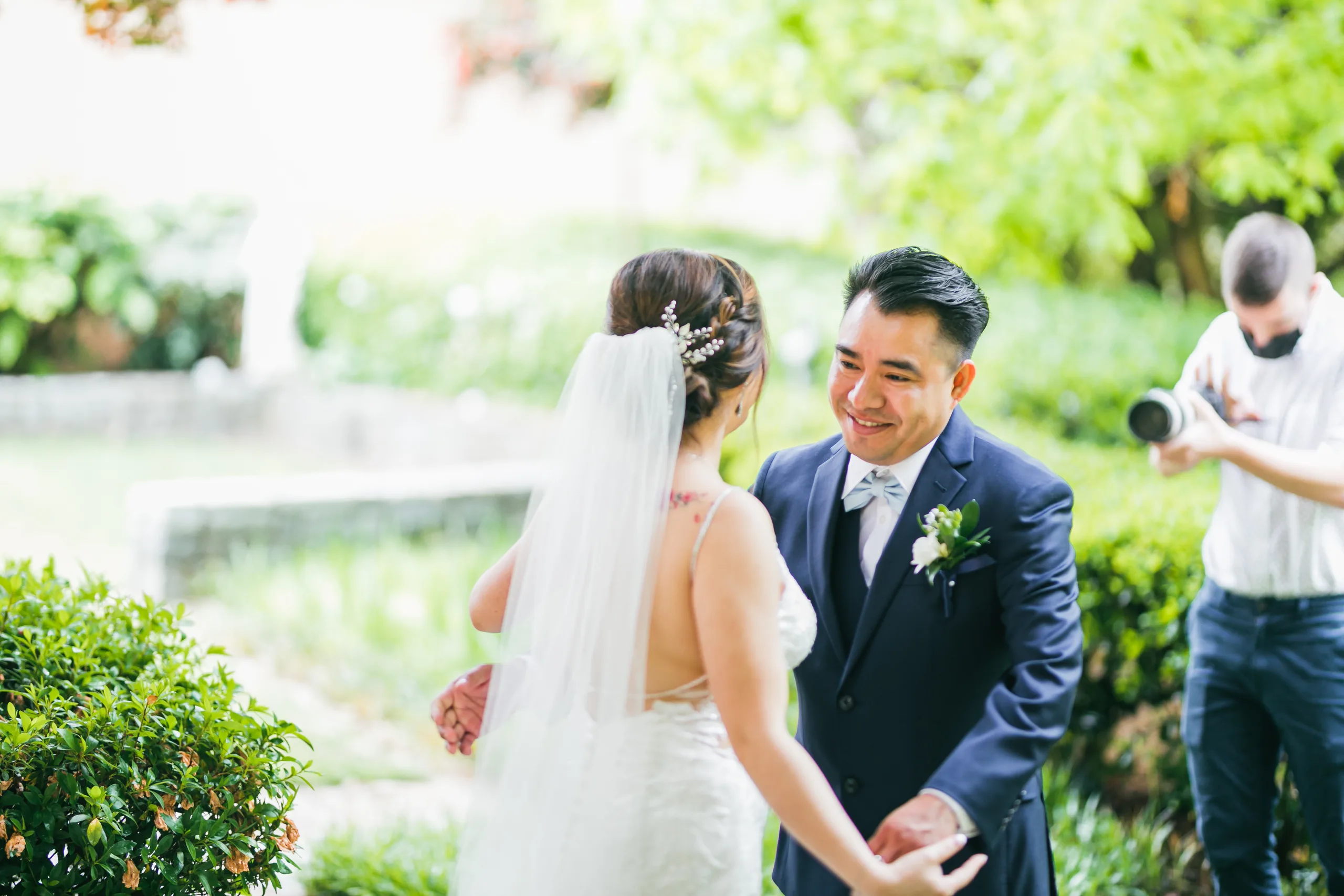 First Look: the groom seeing the bride for the first time before their wedding at Holy Cross Catholic Church in Atlanta, GA