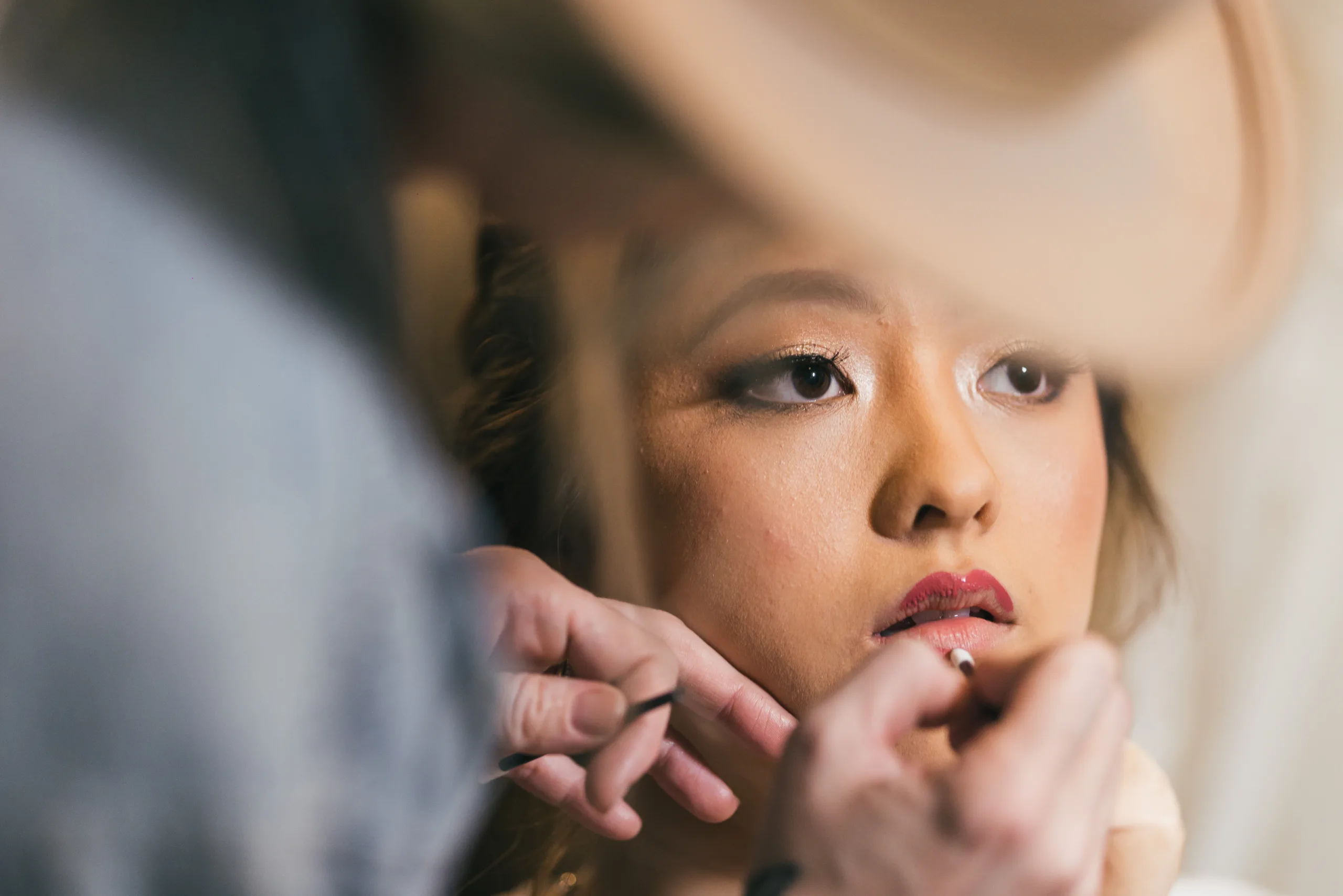 Getting Ready: the bride having her makeup done before their wedding at the Payne-Corley House in Duluth, GA