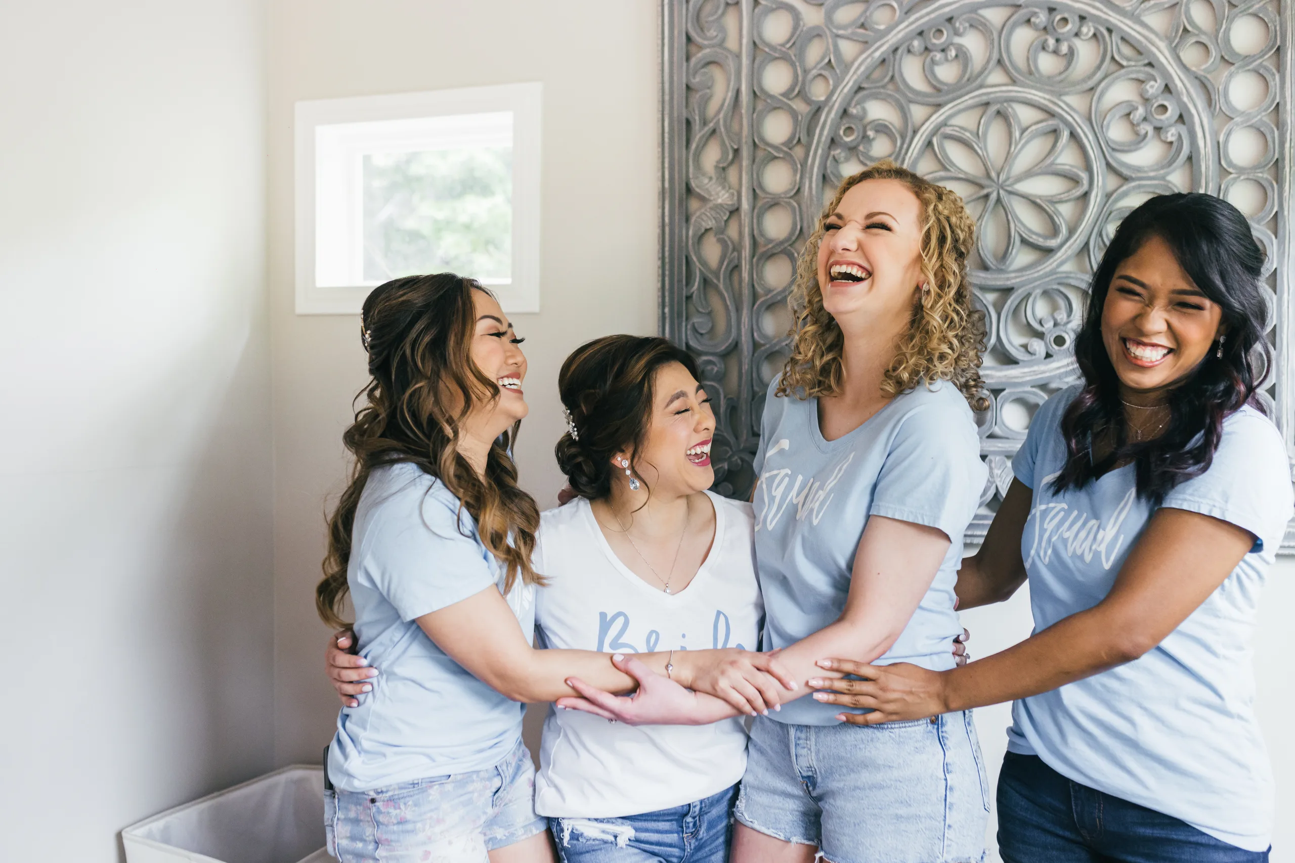 Getting Ready: the bride laughing with her bridesmaids in matching shirts before their wedding at the Payne-Corley House in Duluth, GA
