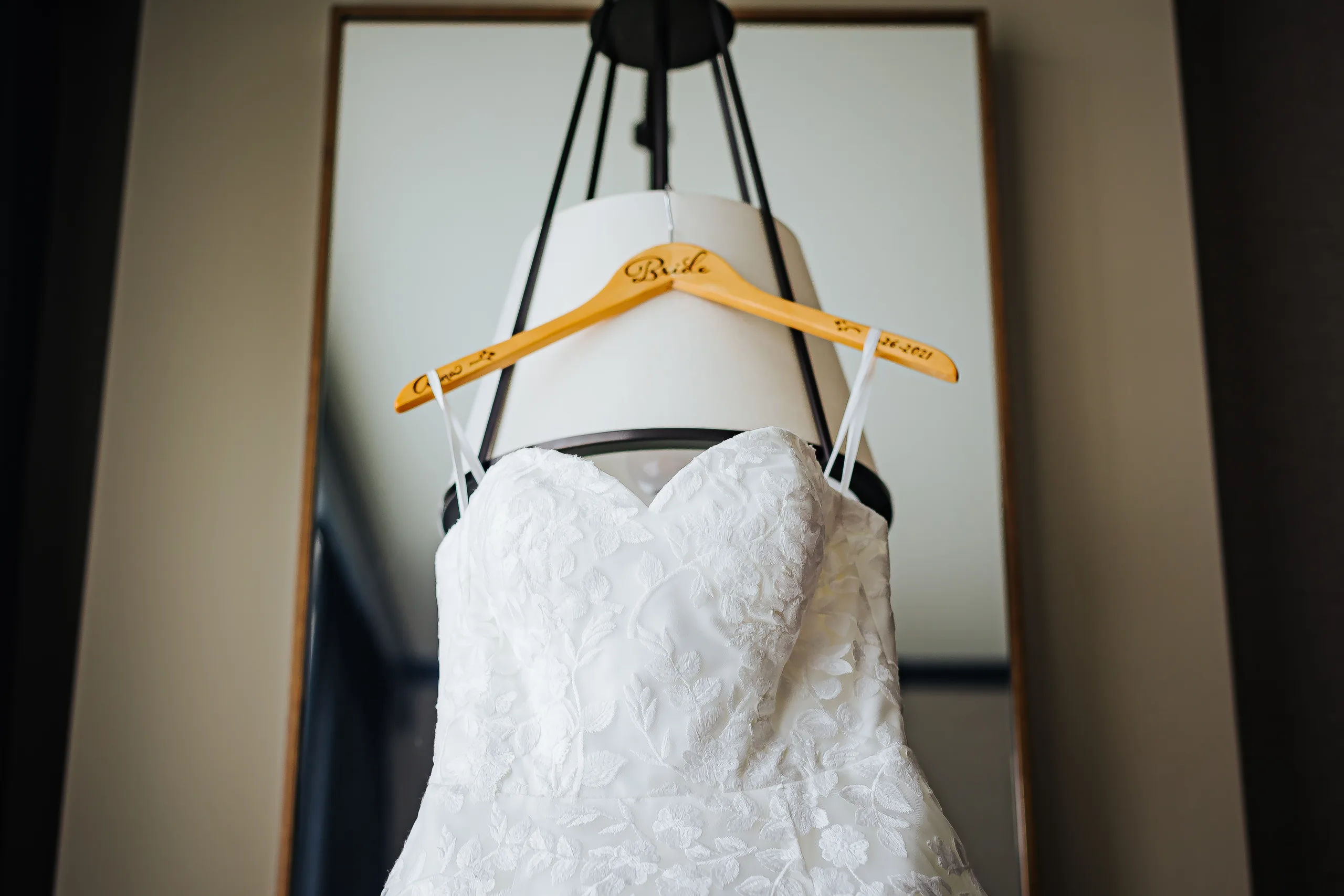 Getting Ready: her lace gown hanging by the window before their wedding at the Omni Hotel at The Battery in Atlanta, GA