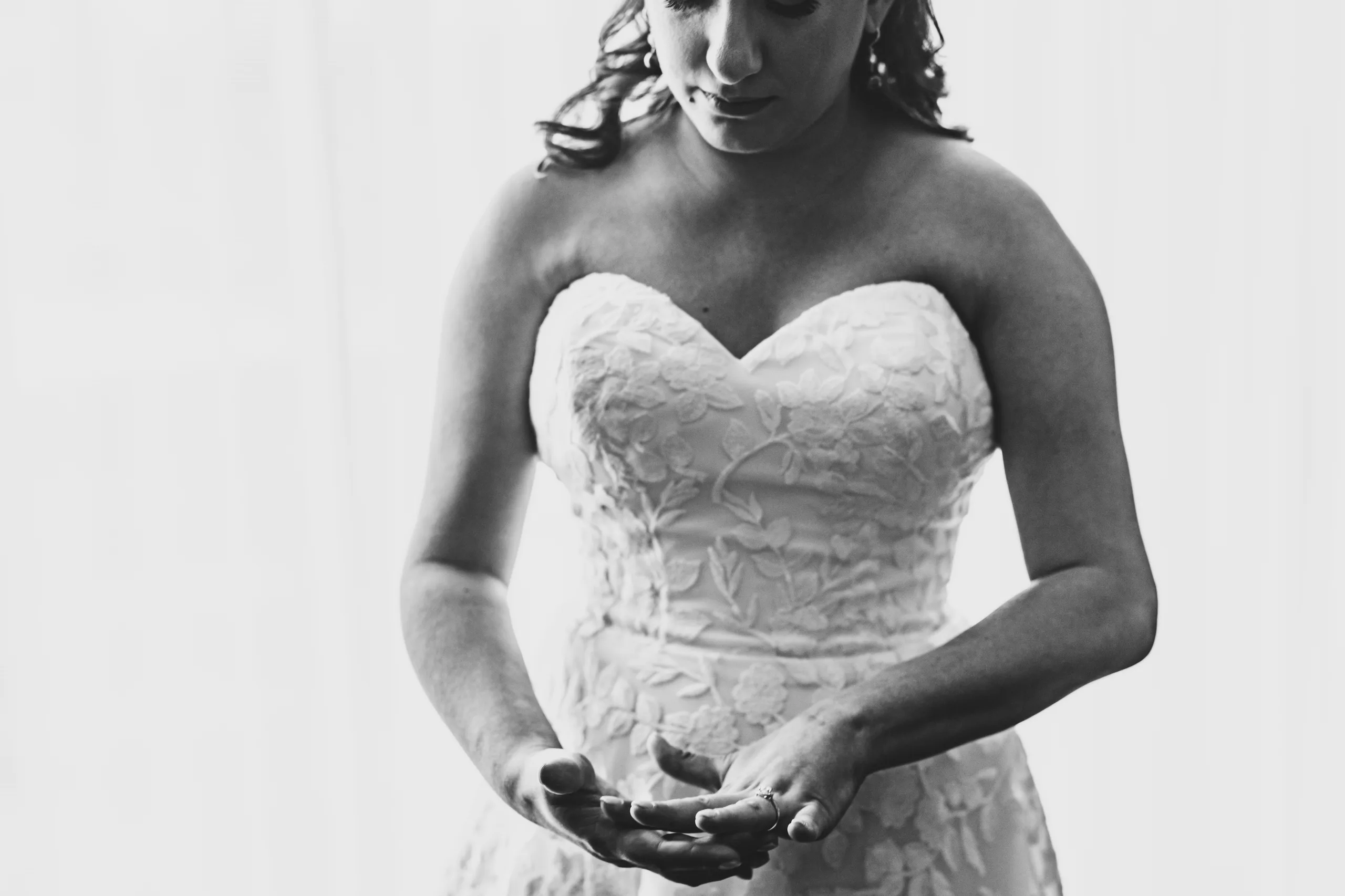 Getting Ready: the bride with her hands together, in black and white before their wedding at the Omni Hotel at The Battery in Atlanta, GA