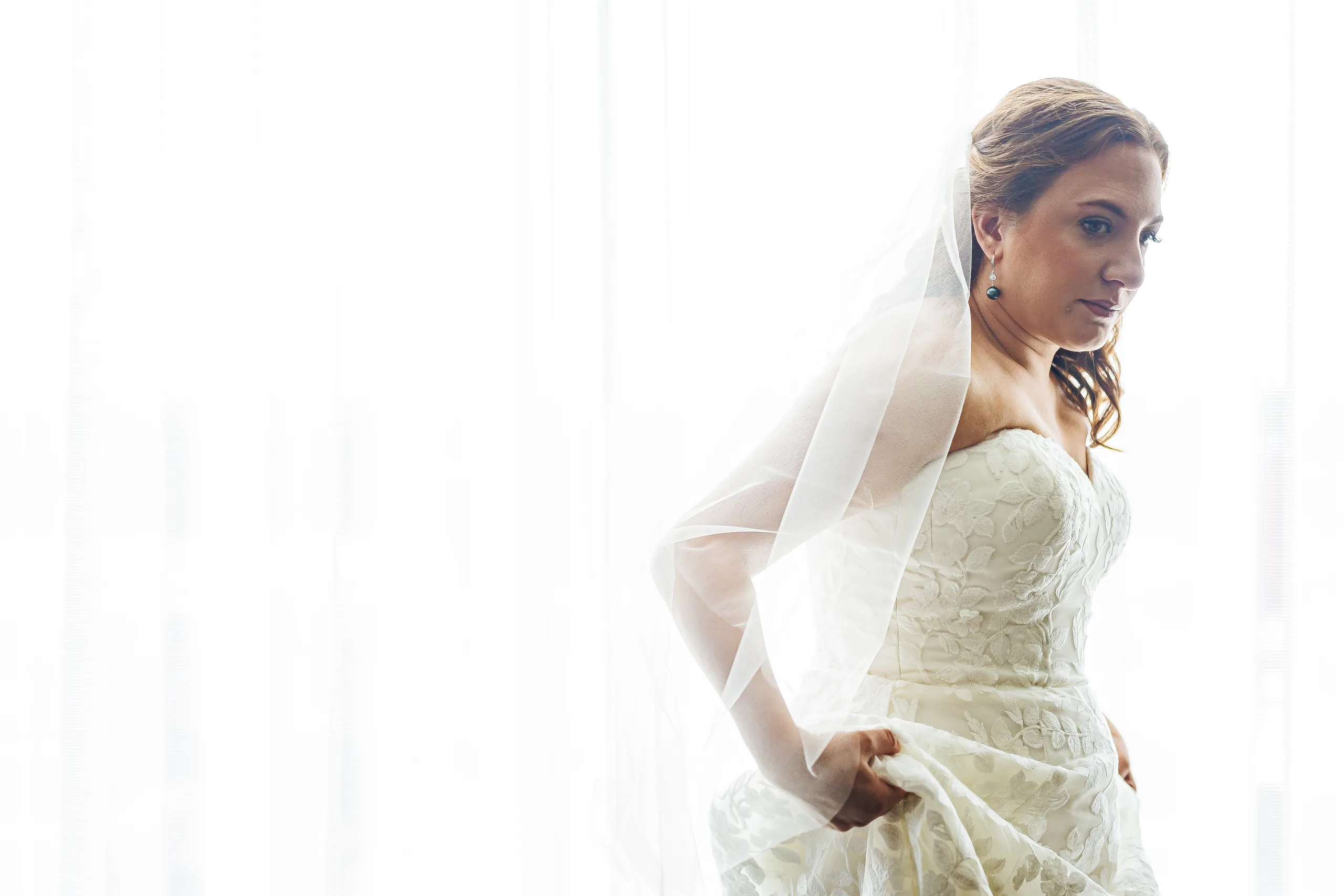 Getting Ready: the bride in her veil before their wedding at the Omni Hotel at The Battery in Atlanta, GA