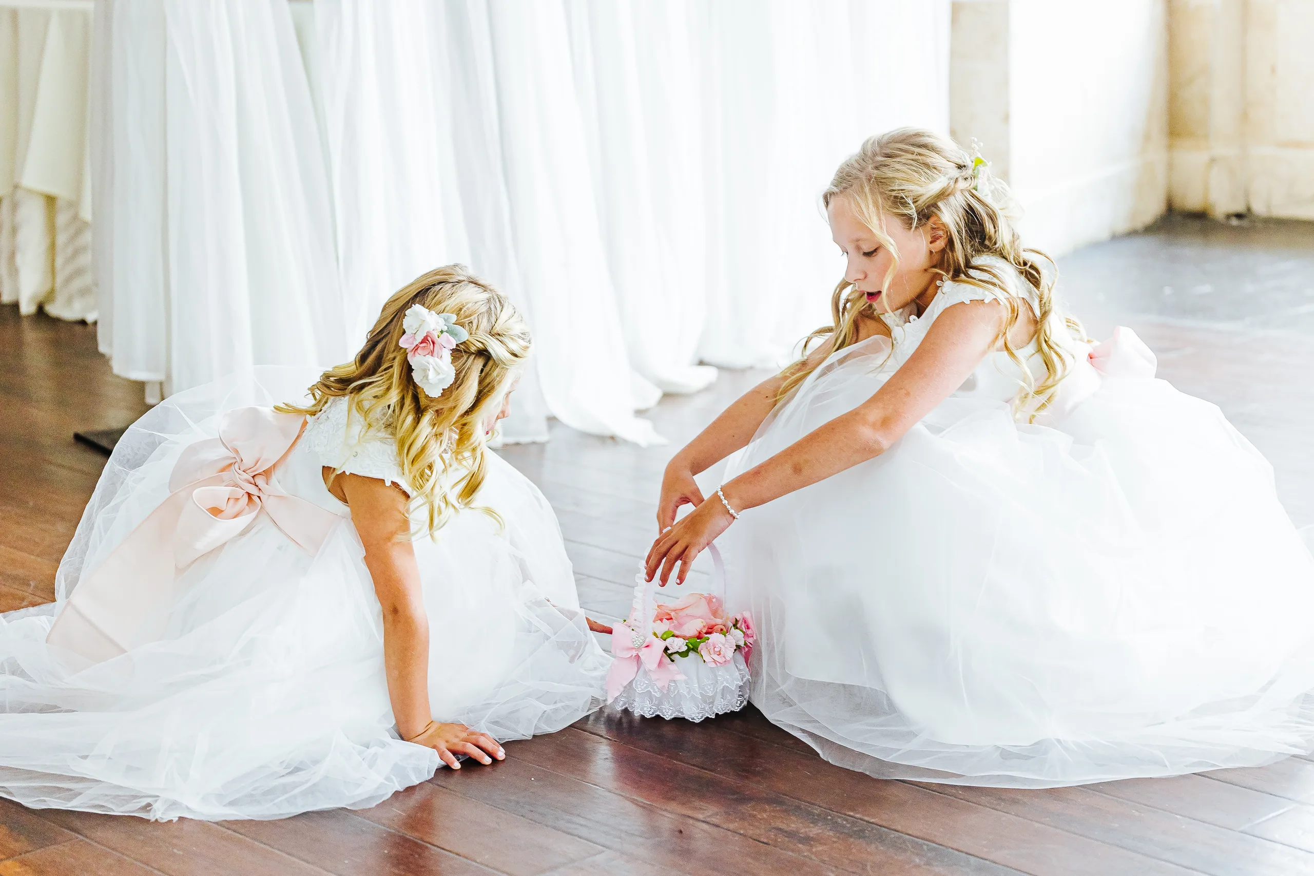 Getting Ready: the two flower girls on the floor with their basket, before their wedding at The Piedmont Room in Atlanta, GA