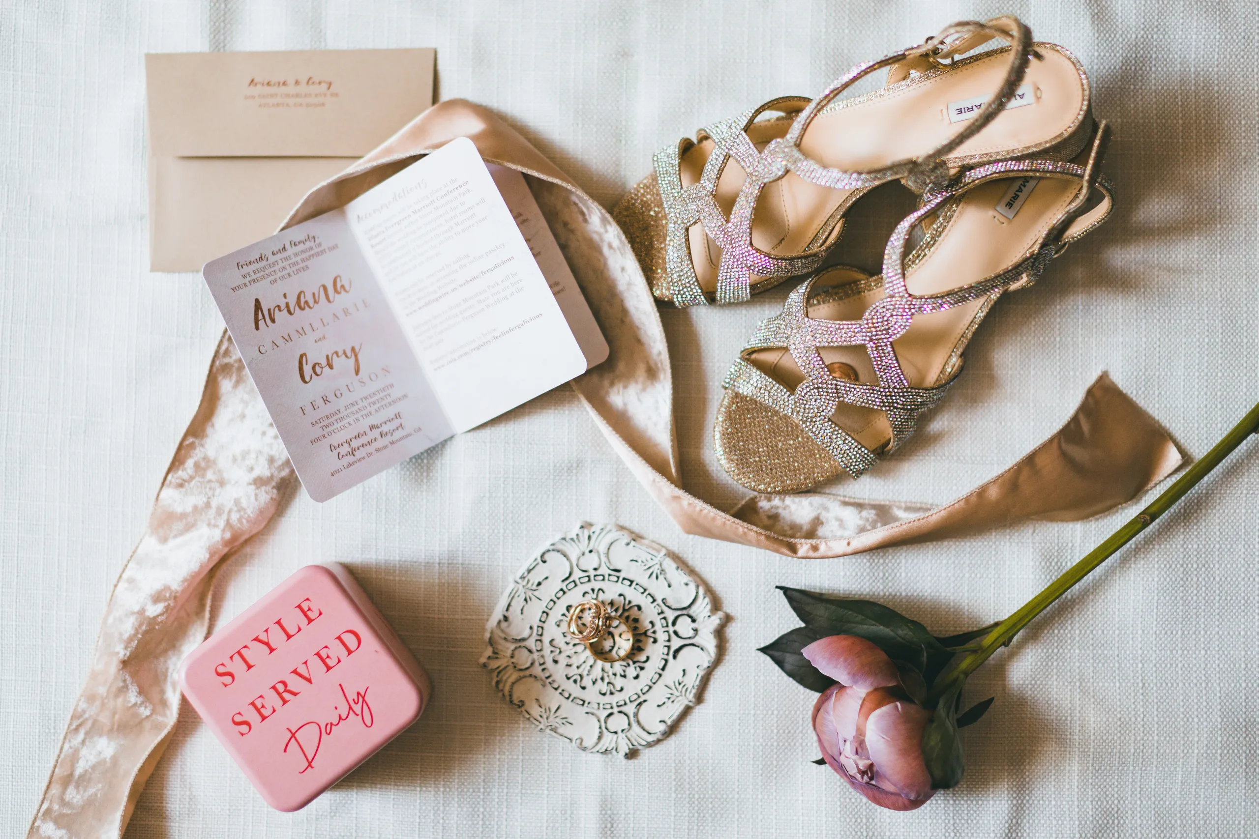 Wedding Details: the invitation, her heels, the rings and a pink peony on velvet ribbon, at a wedding at Atlanta Evergreen Lakeside Resort in Stone Mountain, GA
