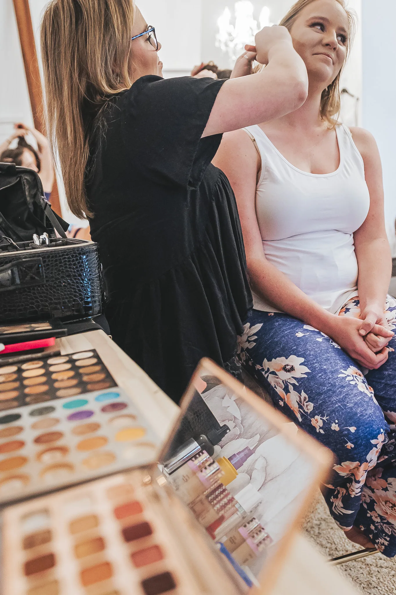 Getting Ready: the bride having her hair done, before their wedding at The Wildflower 301 in Greensboro, GA