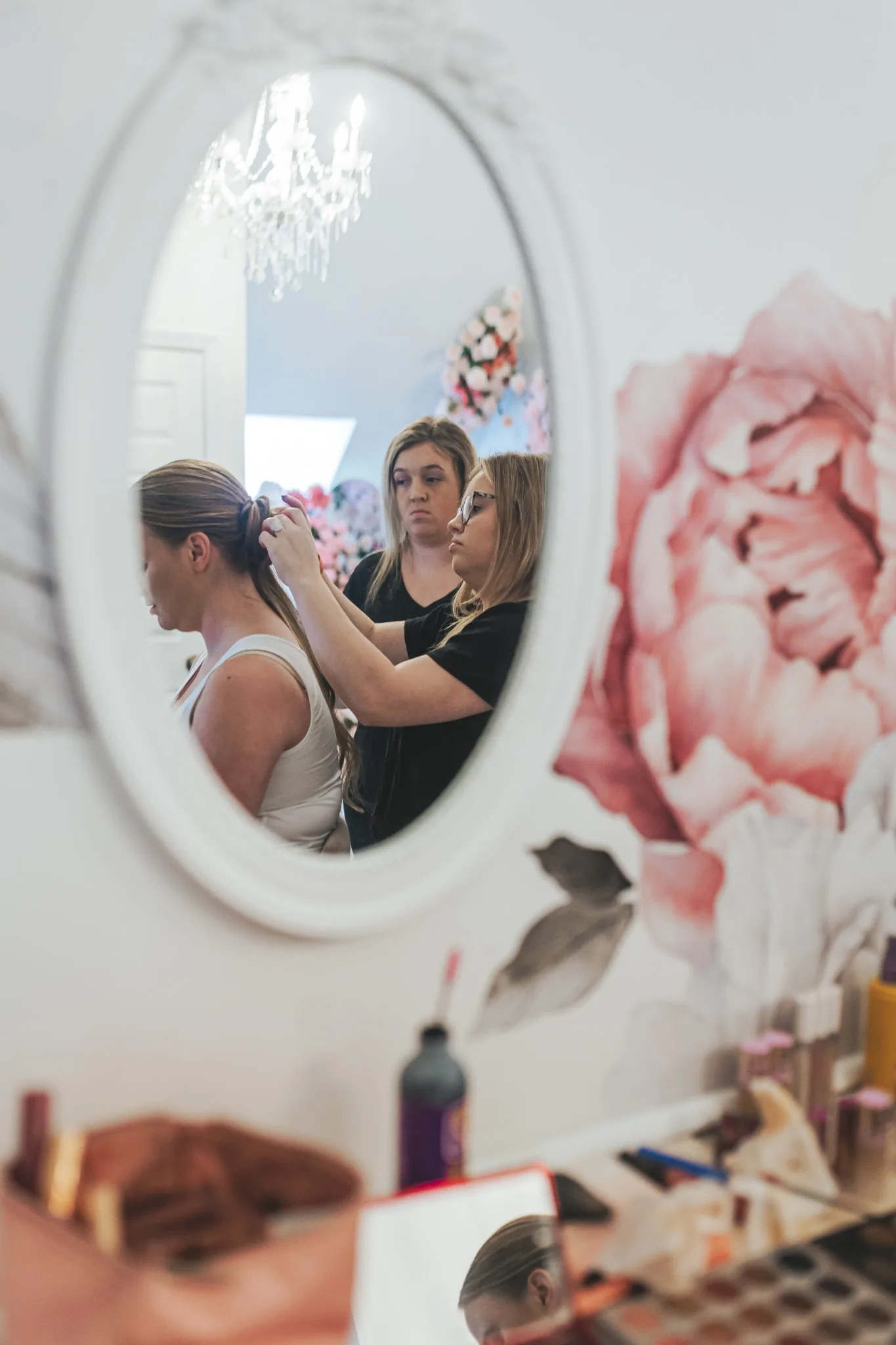 Getting Ready: the bride's hair being pinned in an oval mirror, before their wedding at The Wildflower 301 in Greensboro, GA