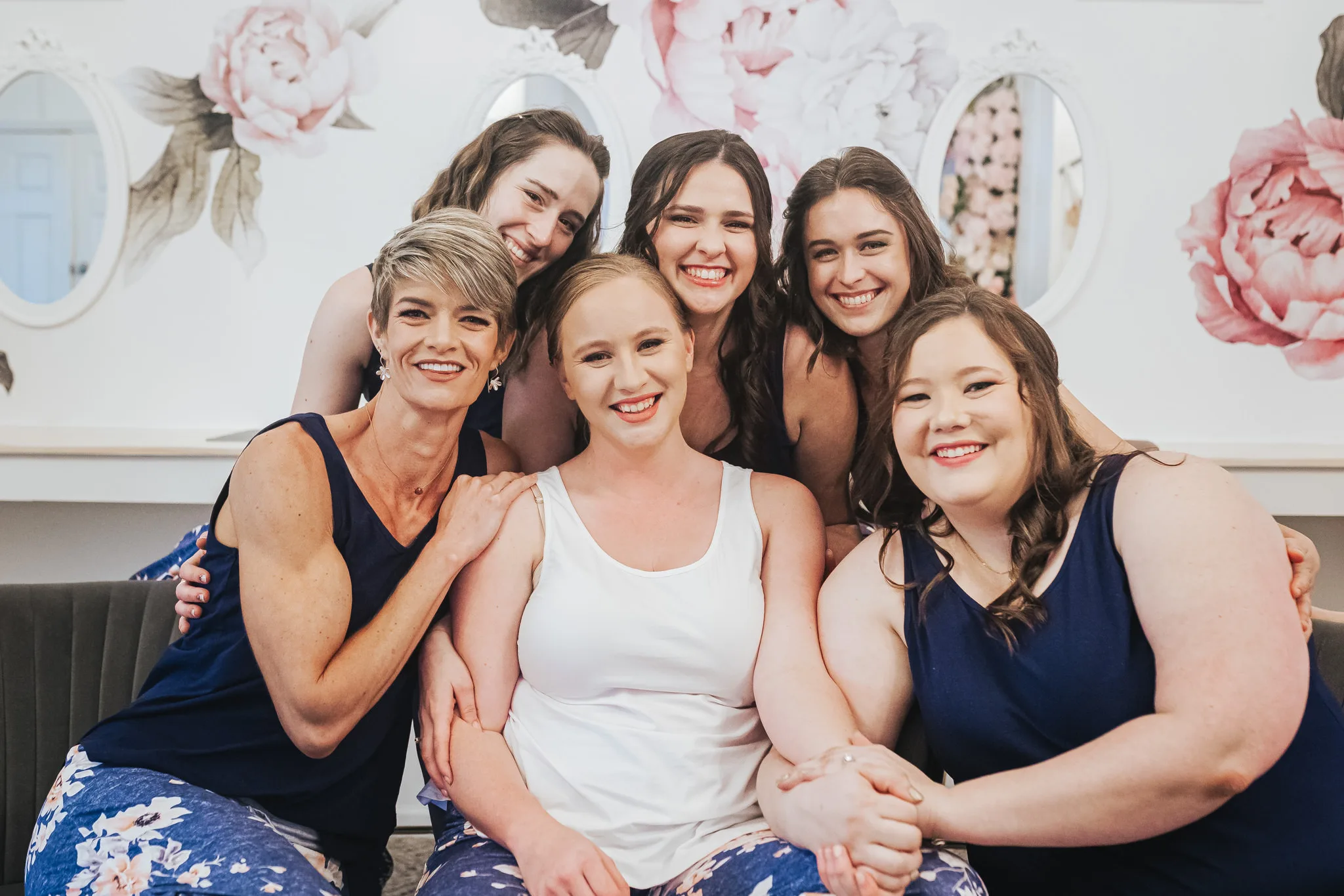 Getting Ready: the bride with her bridesmaids in matching floral pajamas, before their wedding at The Wildflower 301 in Greensboro, GA