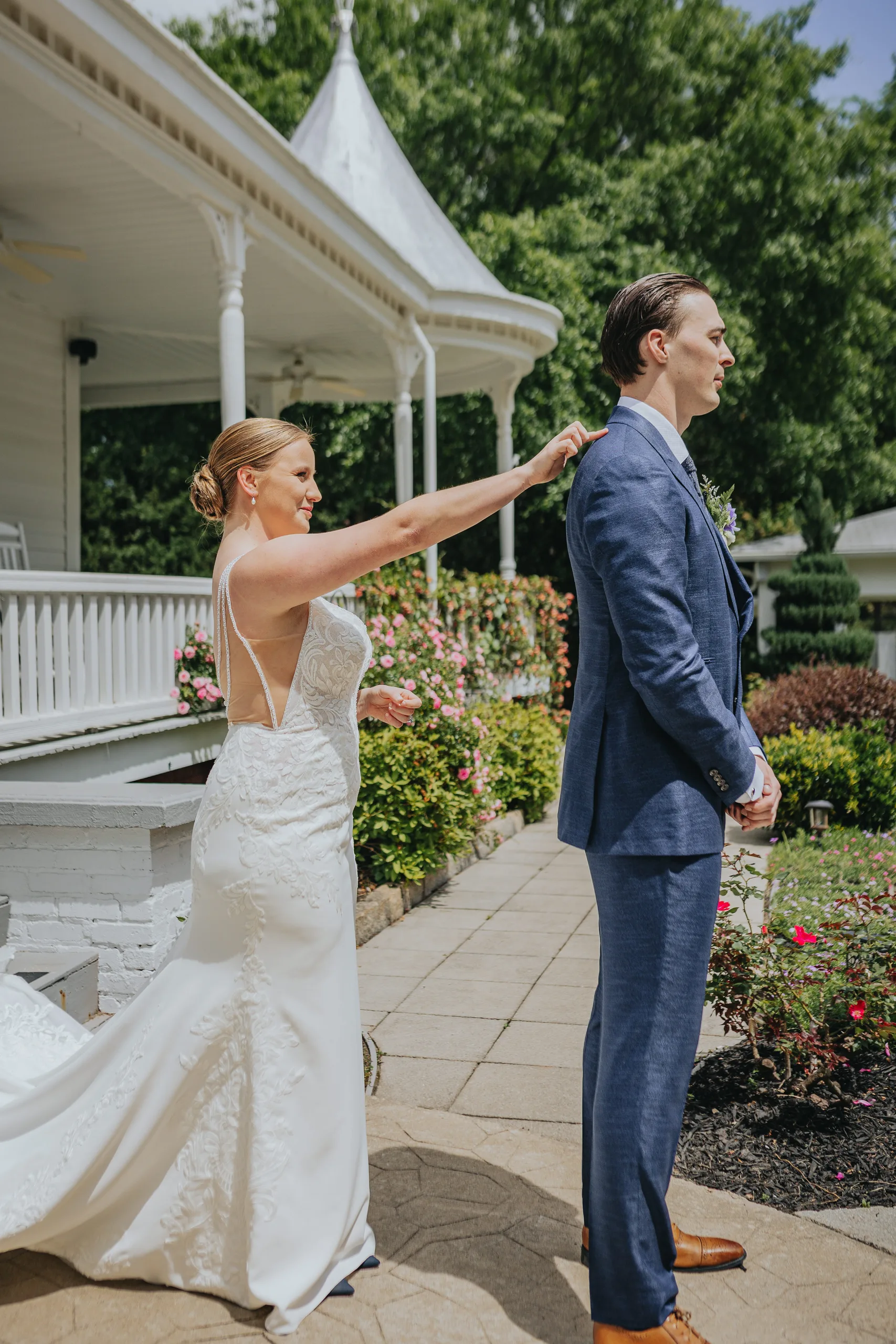 First Look: the bride tapping the groom on the shoulder, before their wedding at The Wildflower 301 in Greensboro, GA