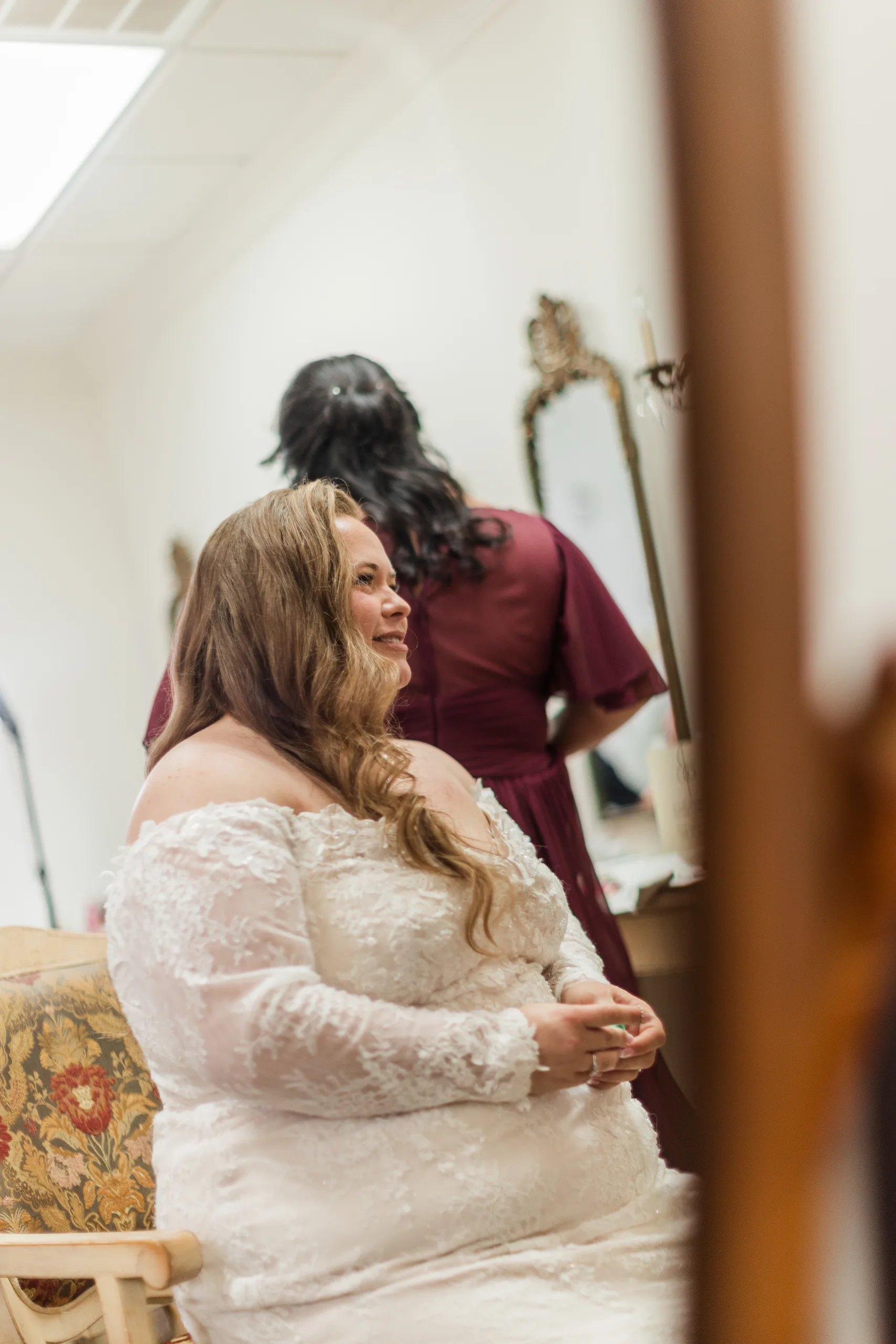 Getting Ready: the bride waiting with a bridesmaid, before their wedding at 550 Trackside in Lawrenceville, GA