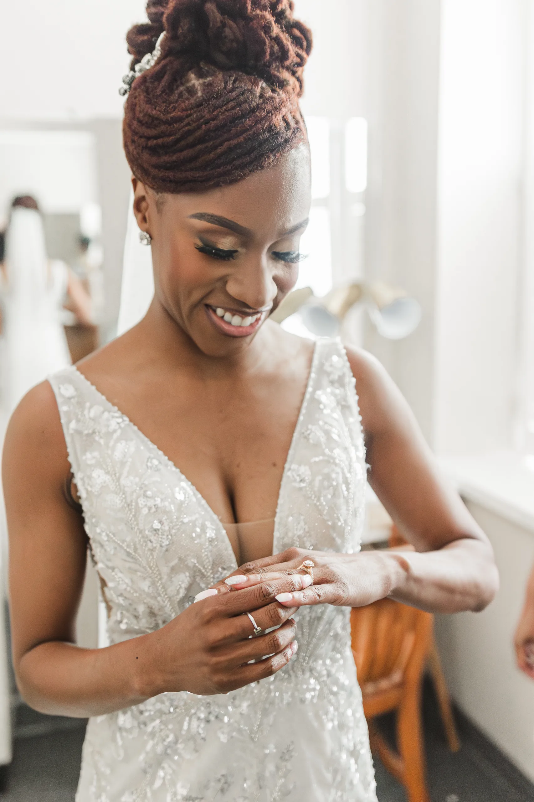 Getting Ready: the bride putting on her ring, before their wedding at the Historic DeKalb Courthouse in Decatur, GA
