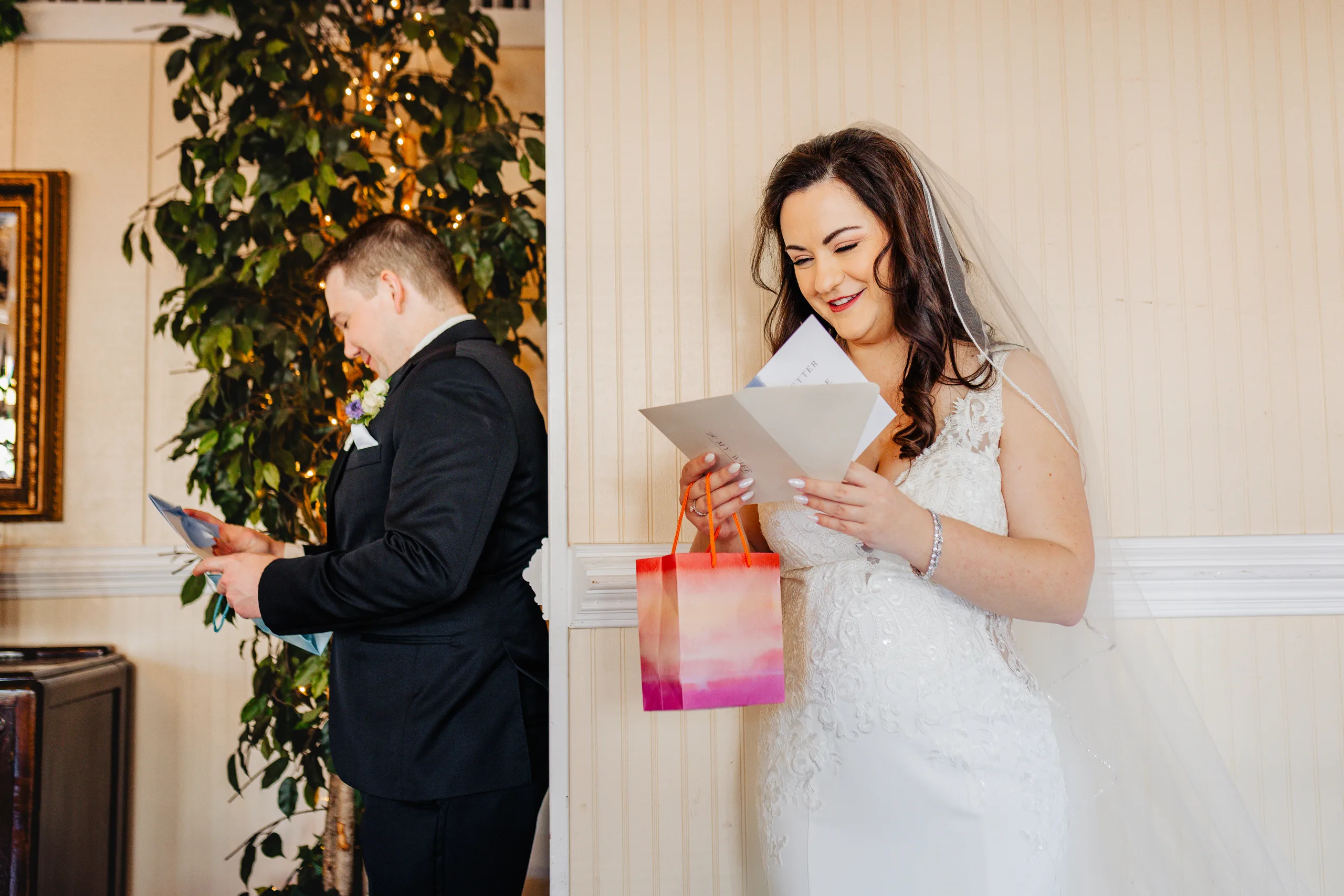 Wedding Details: the bride laughing as she reads her letter at their wedding at Ivy Hall at Roswell Mill in Roswell, GA