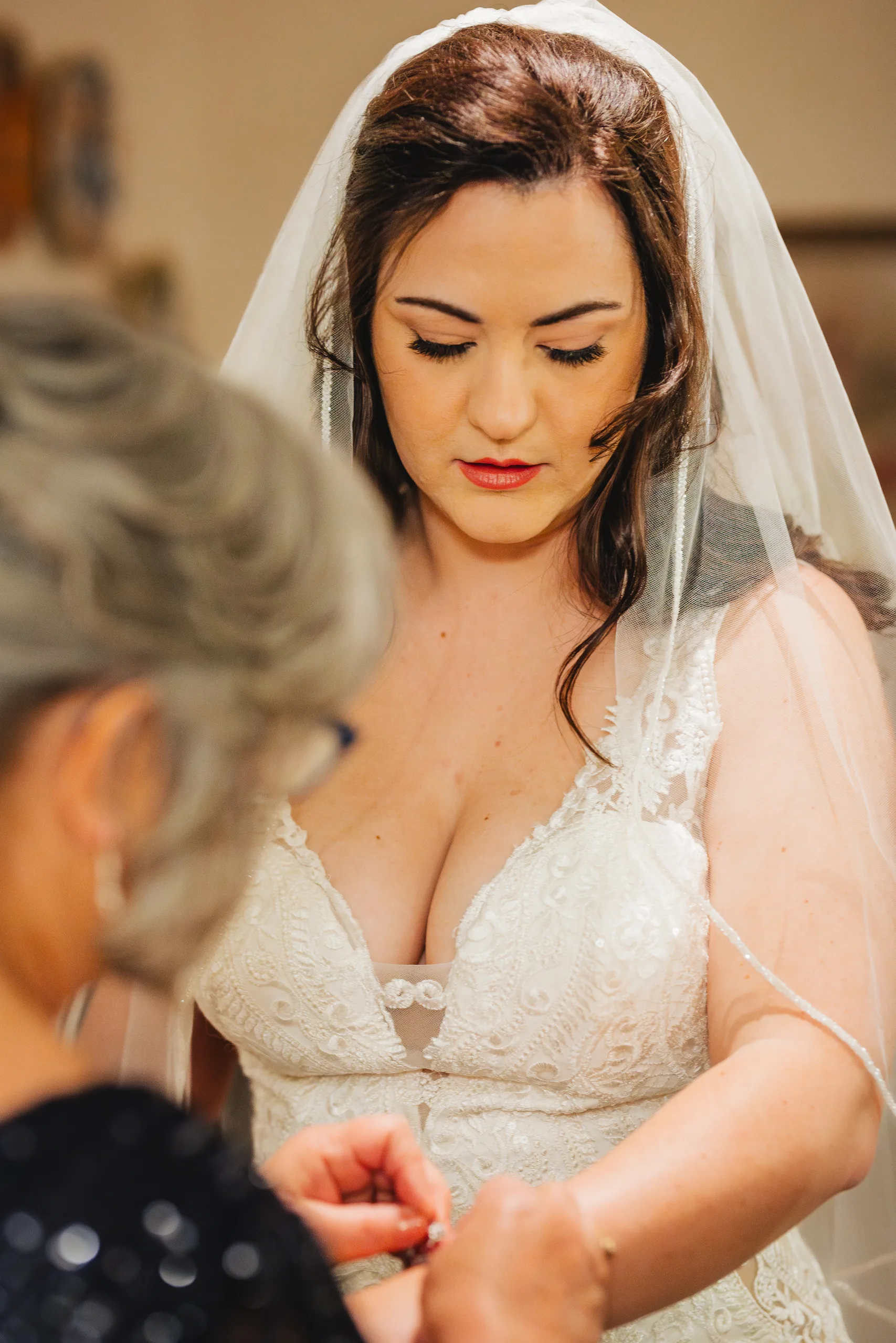 Getting Ready: her mom helping with her bracelet before their wedding at Ivy Hall at Roswell Mill in Roswell, GA