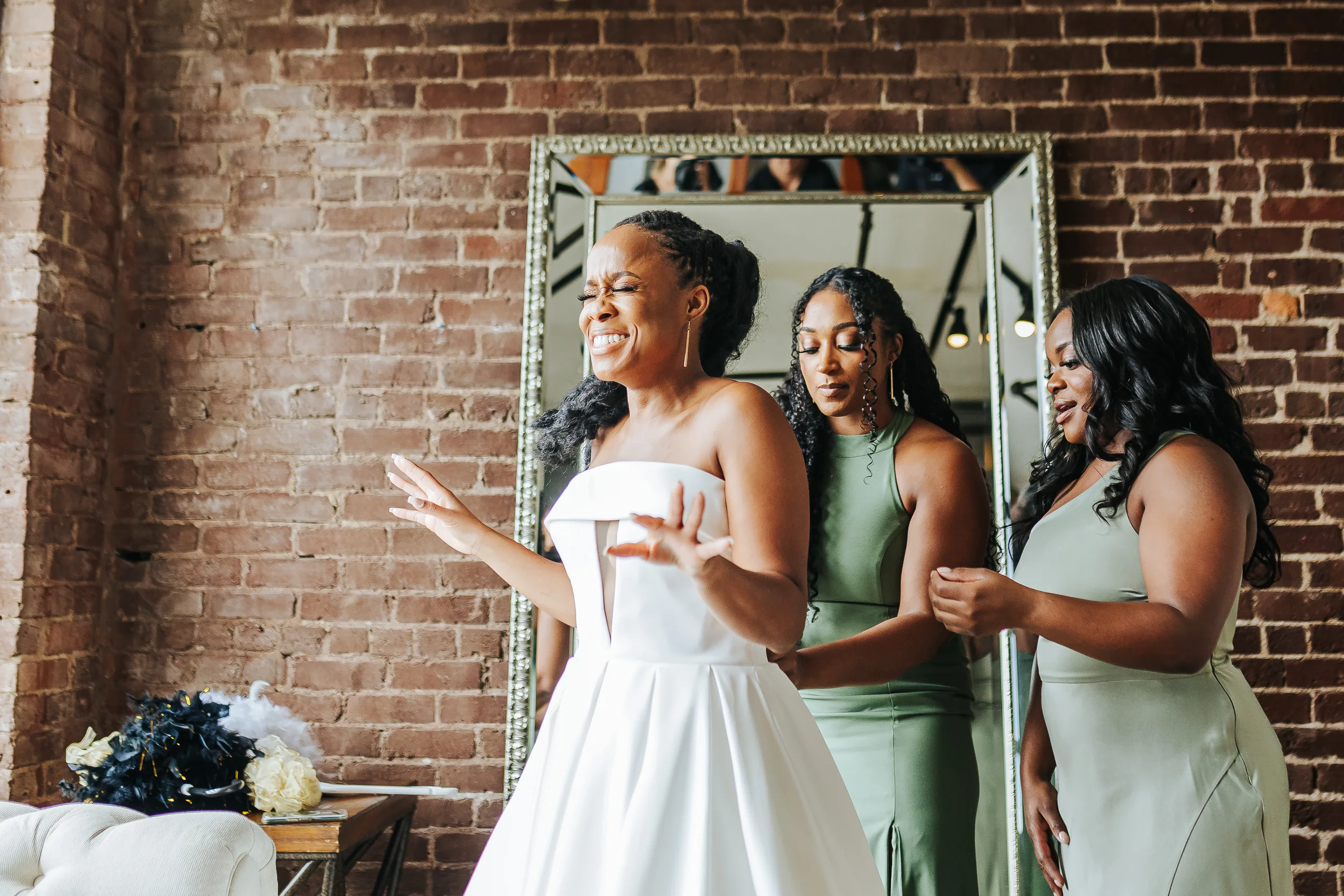 Getting Ready: the bride dancing in front of the mirror with her bridesmaids, before their wedding at Terminus 330 in Atlanta, GA