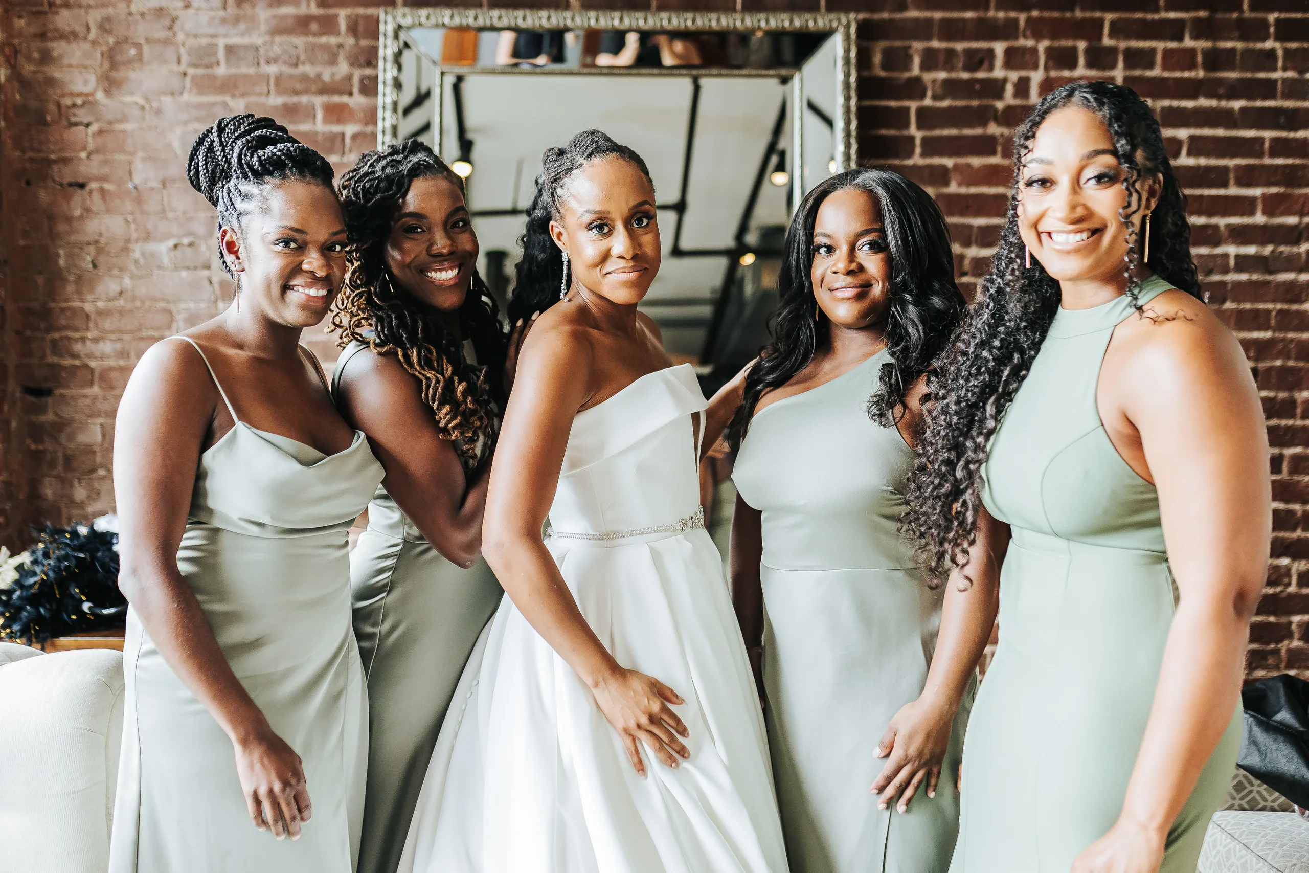 Getting Ready: the bride with her bridesmaids in sage green, before their wedding at Terminus 330 in Atlanta, GA