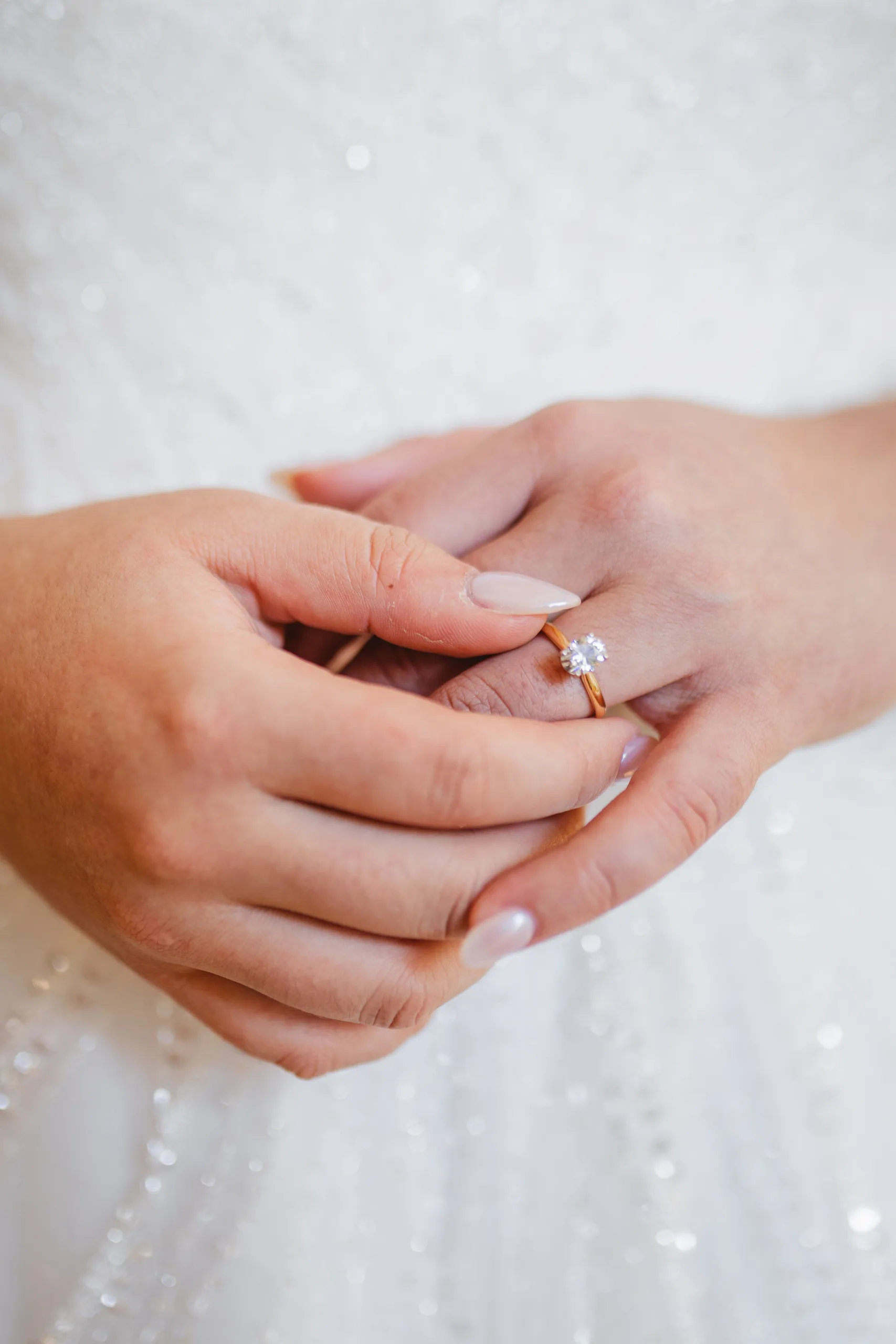Getting Ready: her engagement ring against the beaded gown, before their wedding at Naylor Hall in Roswell, GA