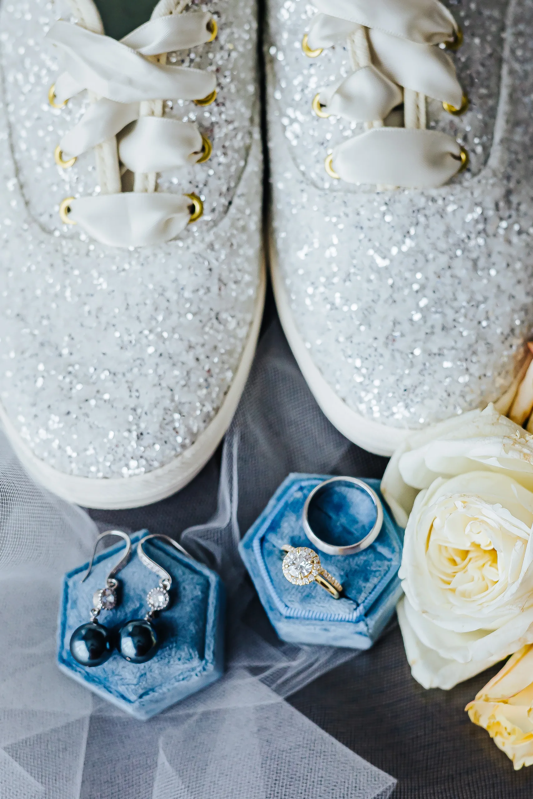 Wedding Details: her glitter Keds, rings and yellow roses on her veil at a wedding at the Omni Hotel at The Battery in Atlanta, GA