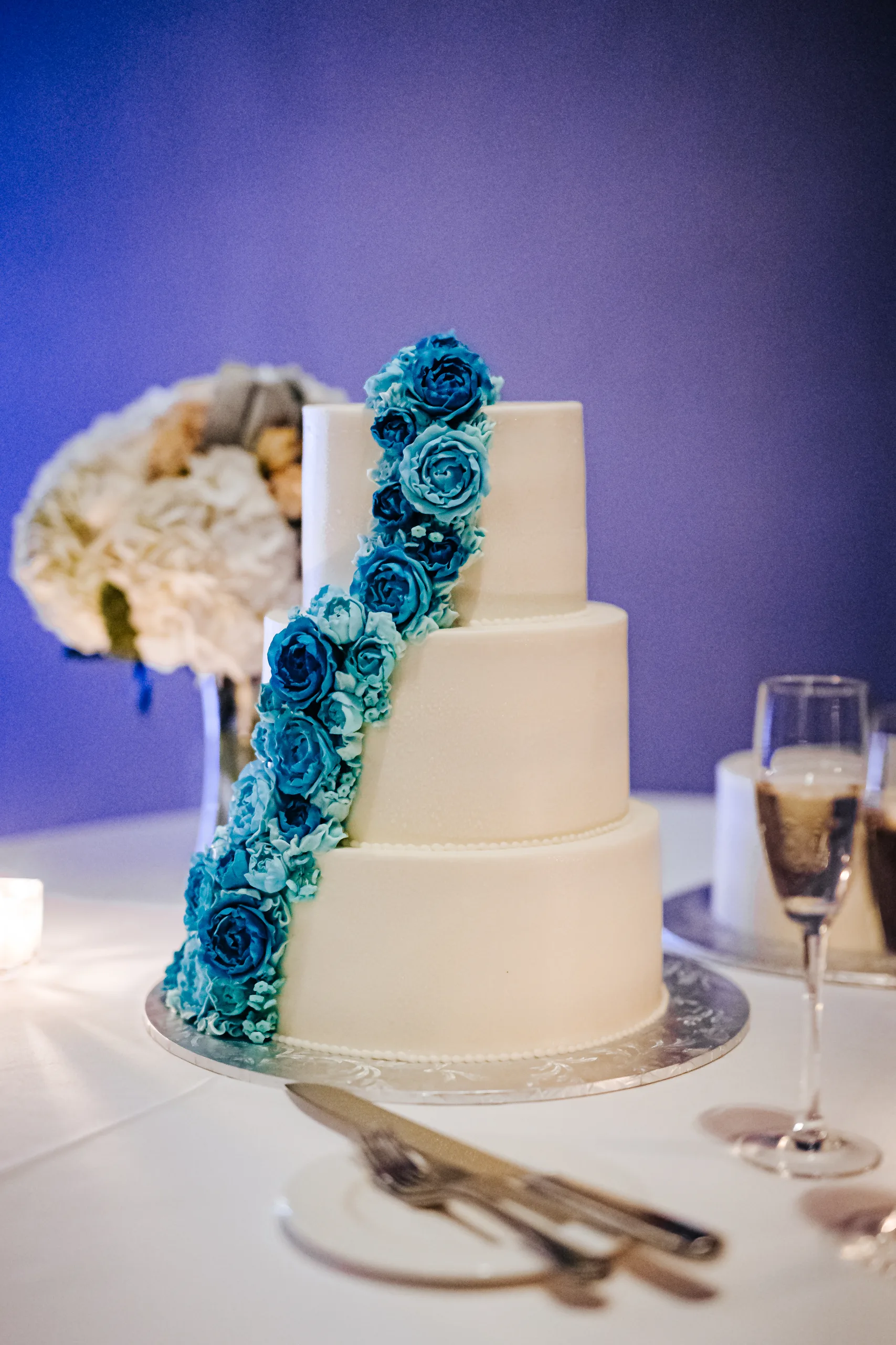 Wedding Cake Details: the three-tier cake in blue light at a wedding at the Omni Hotel at The Battery in Atlanta, GA